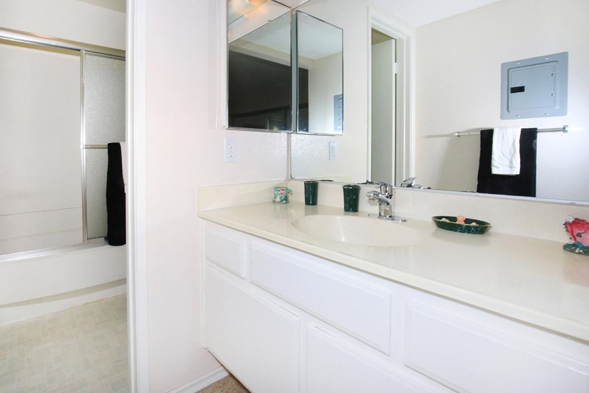 a kitchen with a sink and a mirror