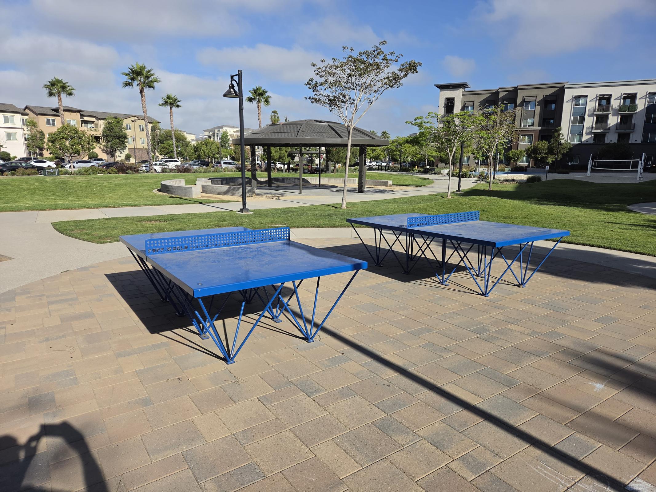 Enjoy sunny days in our vibrant outdoor space, perfect for friendly competitions at the ping pong tables or relaxing under the gazebo in a welcoming community atmosphere!