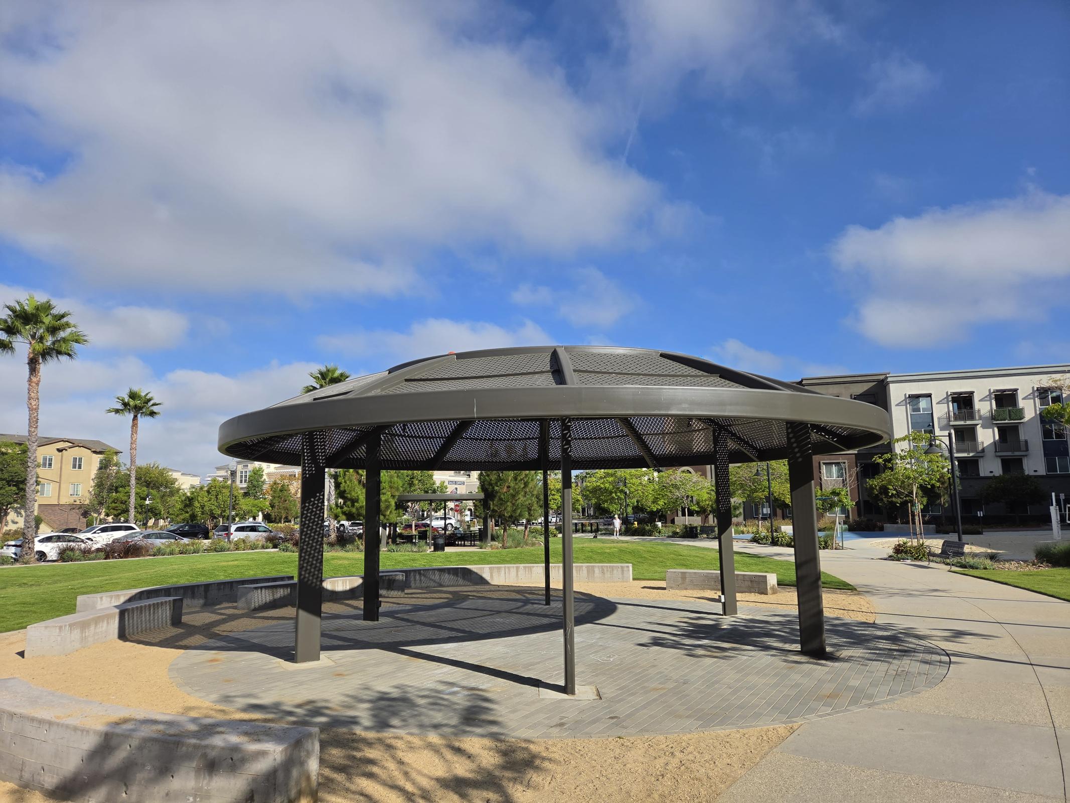 Relax and unwind in our beautiful community gazebo, surrounded by lush greenery and vibrant social spaces, perfect for enjoying sunny days with friends and neighbors.
