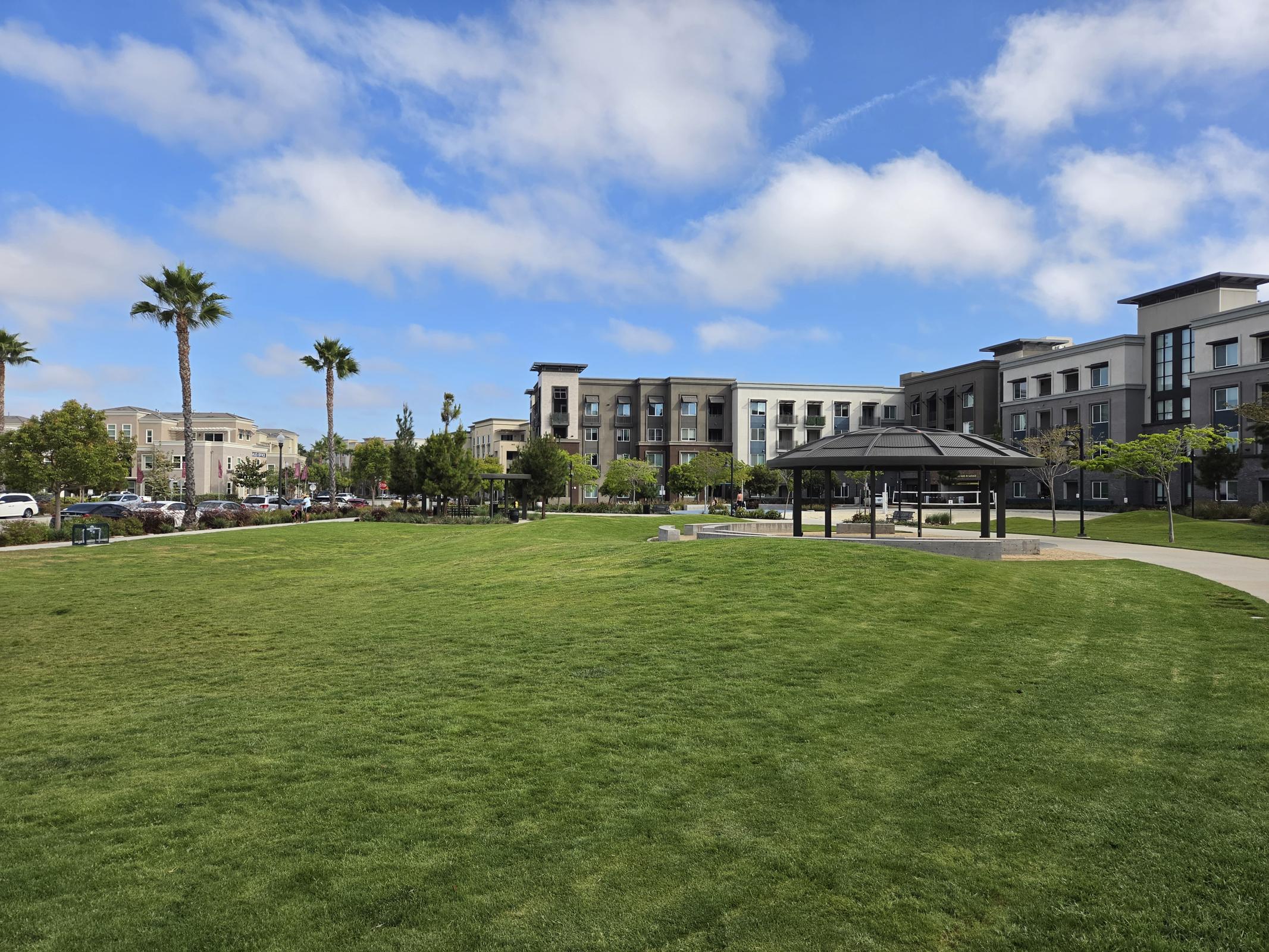 Discover a serene oasis just steps from your door, where lush green spaces meet modern living, perfect for relaxation and community gatherings under the sunny sky.