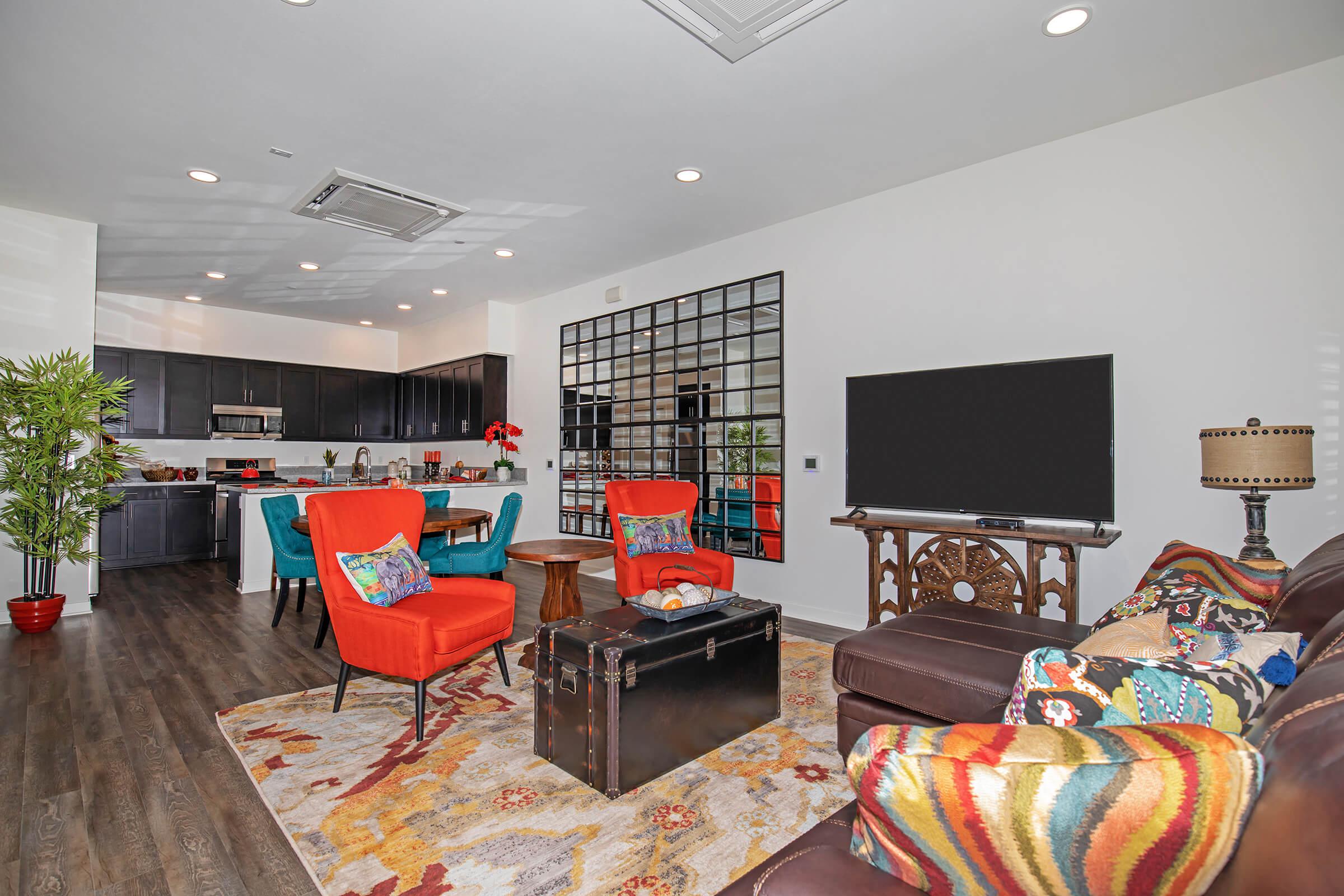 furnished living room with red chairs