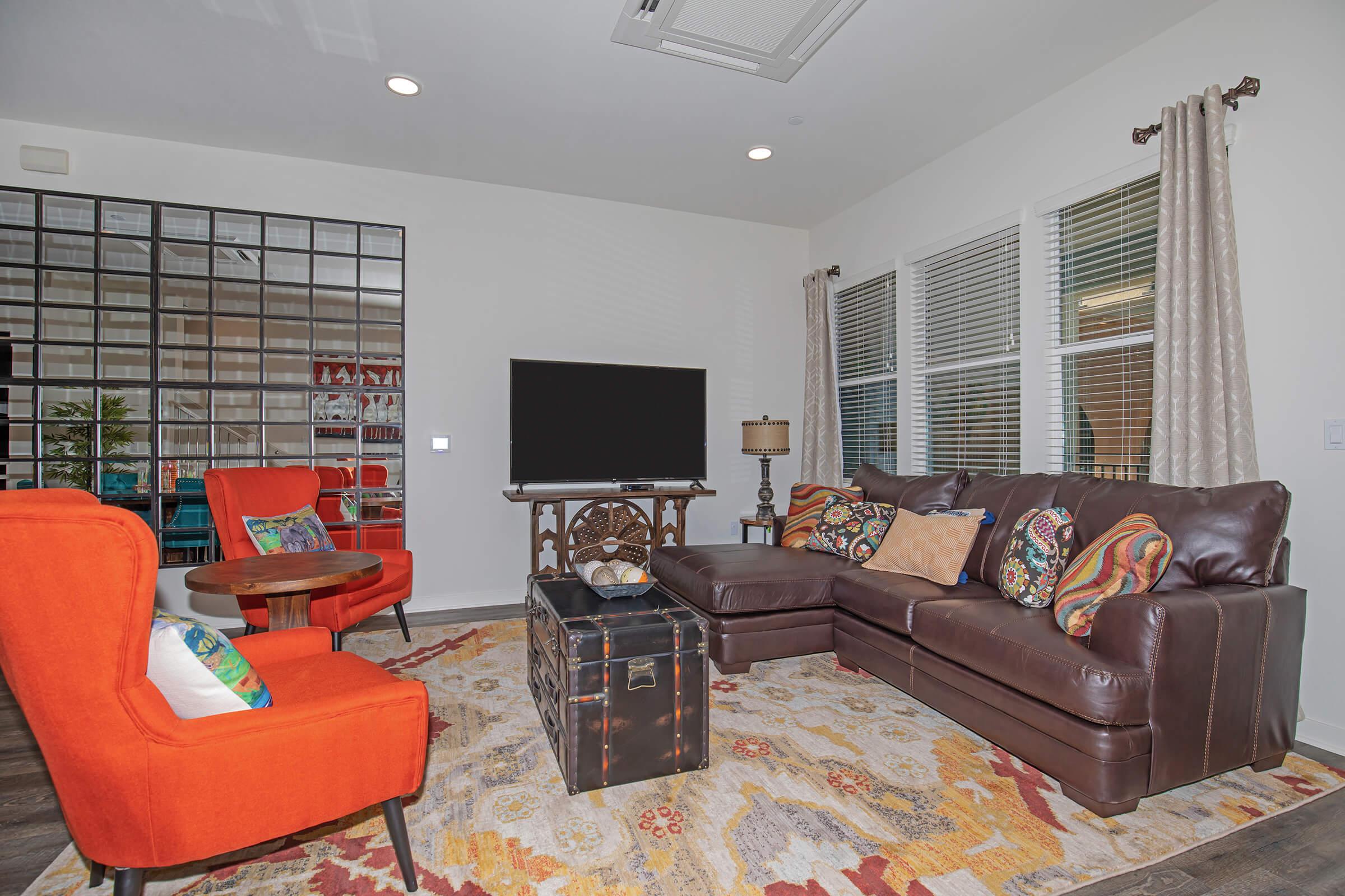 furnished living room with a brown couch