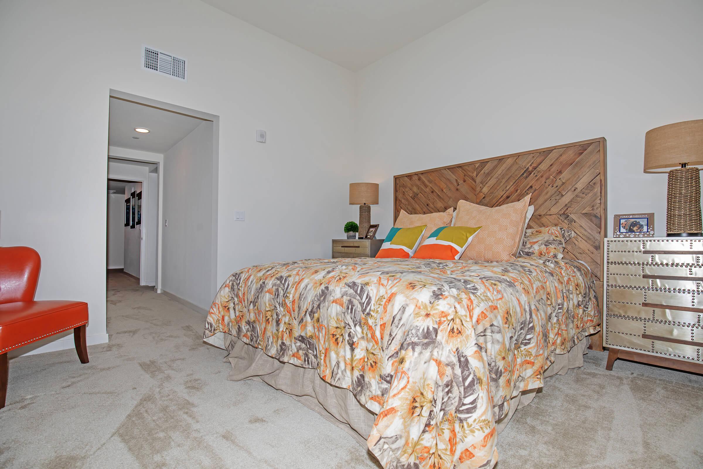 carpeted bedroom with a red chair