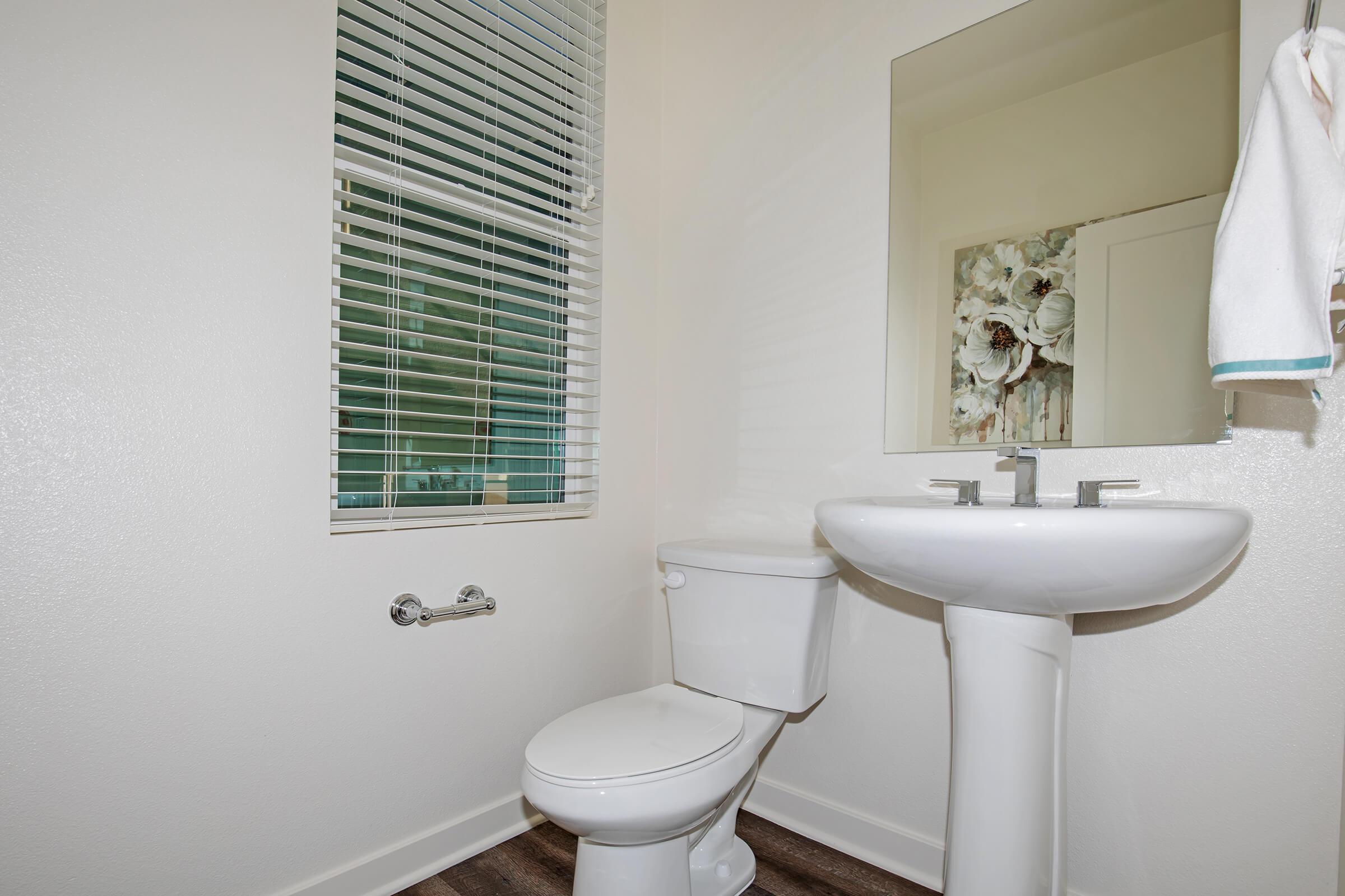 vacant bathroom with wooden floors