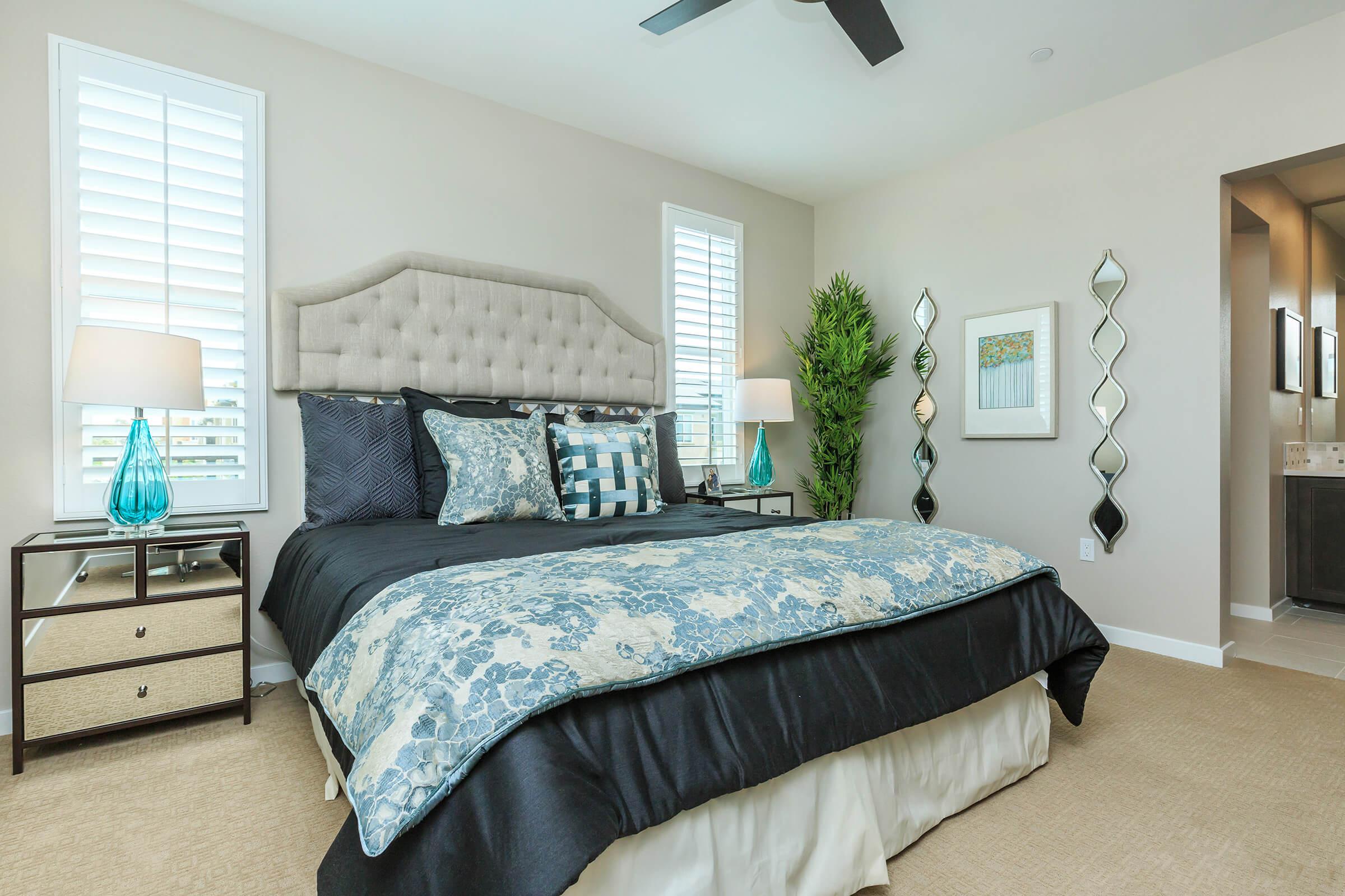 carpeted bedroom with mirrored night table