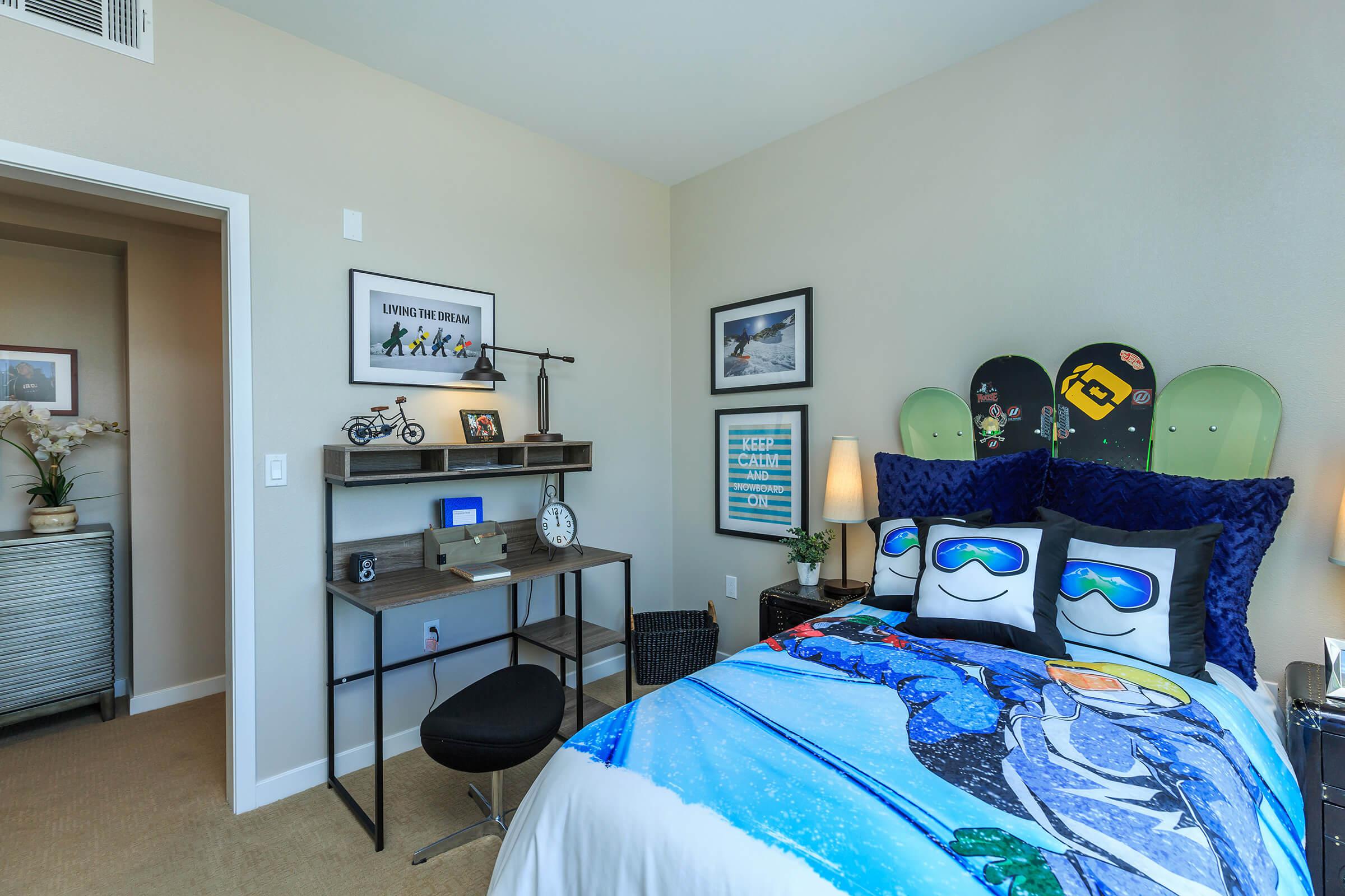 furnished bedroom with a wooden desk