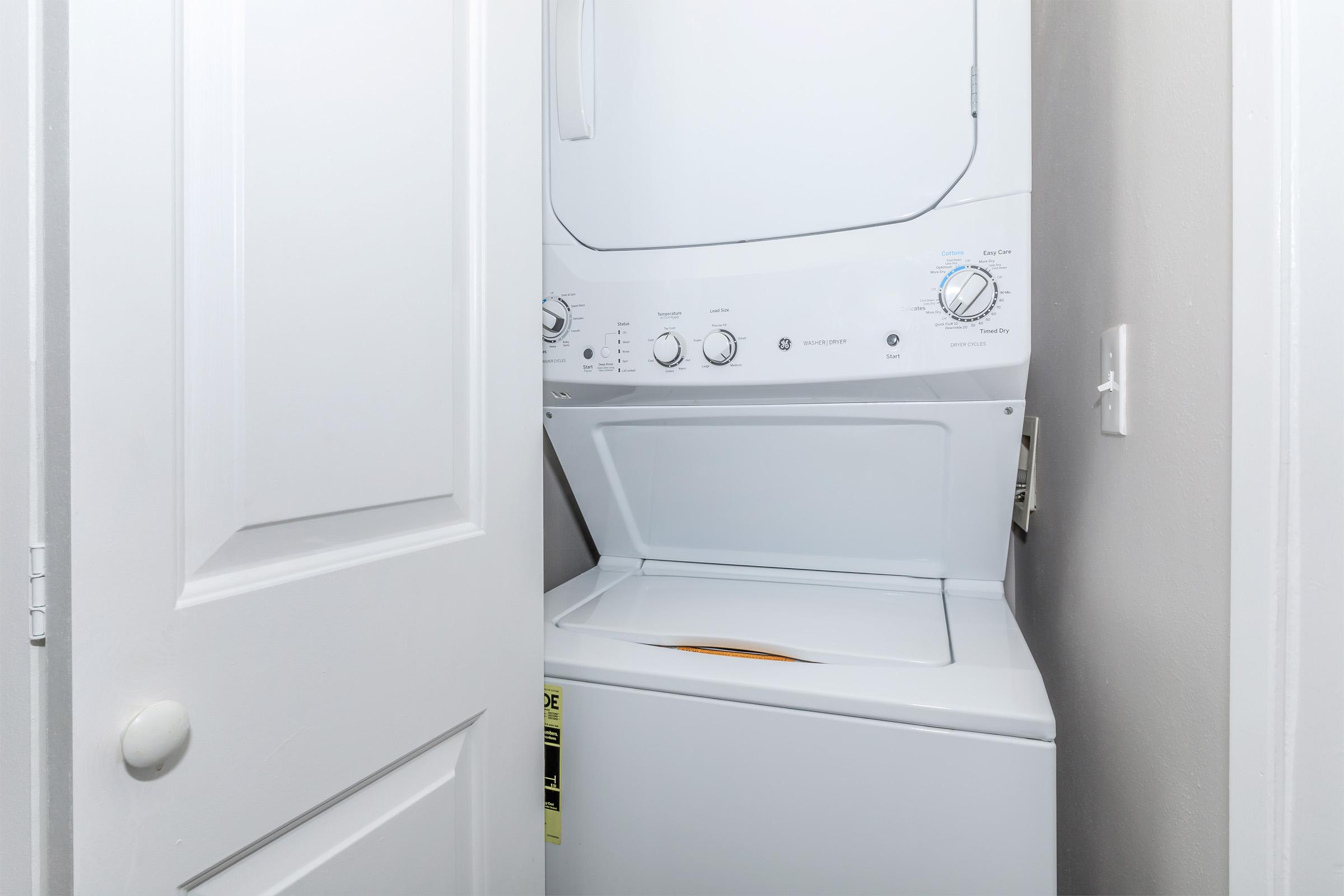 a microwave oven sitting on top of a refrigerator