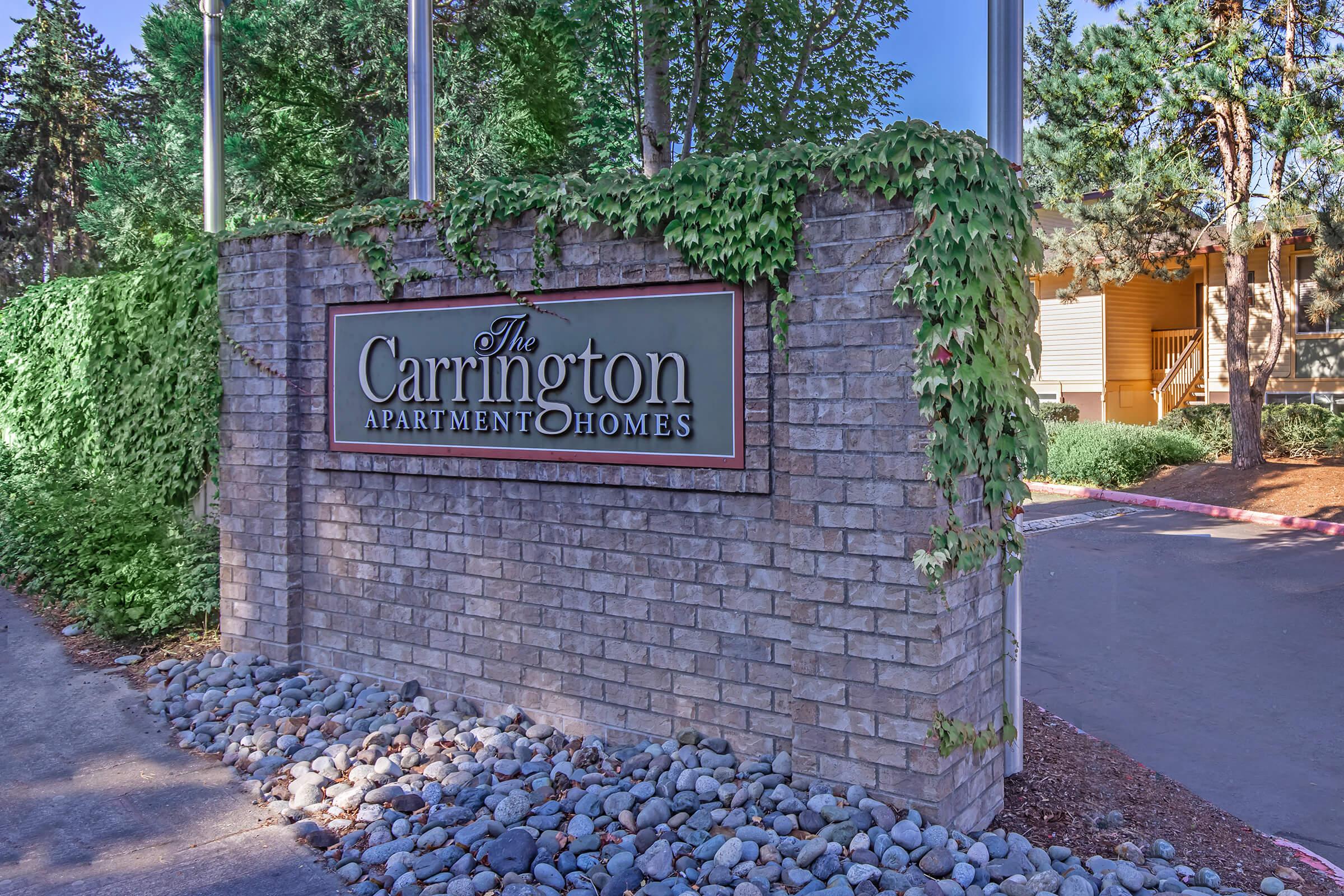 a sign in front of a brick building