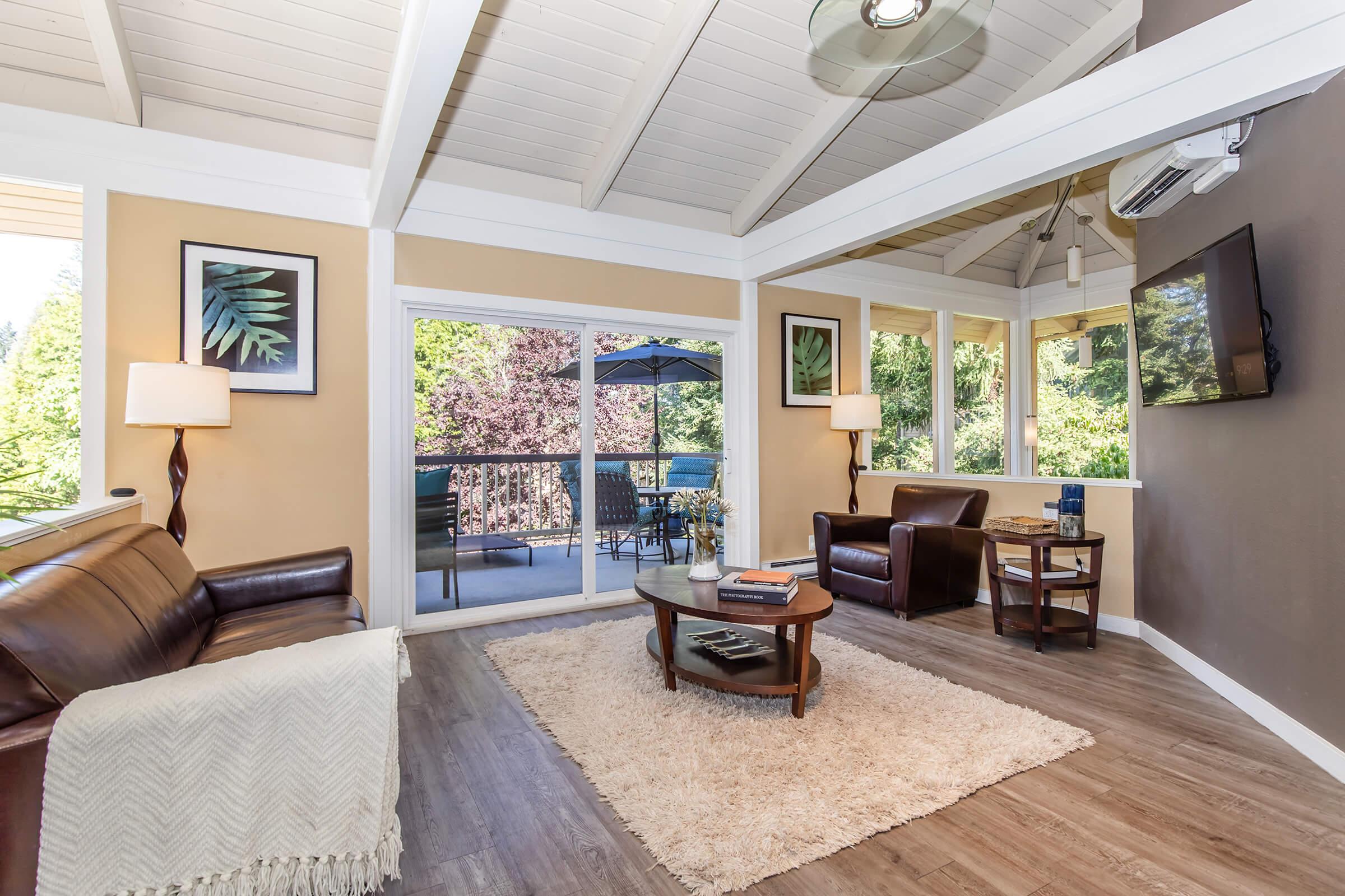 a living room filled with furniture and a large window