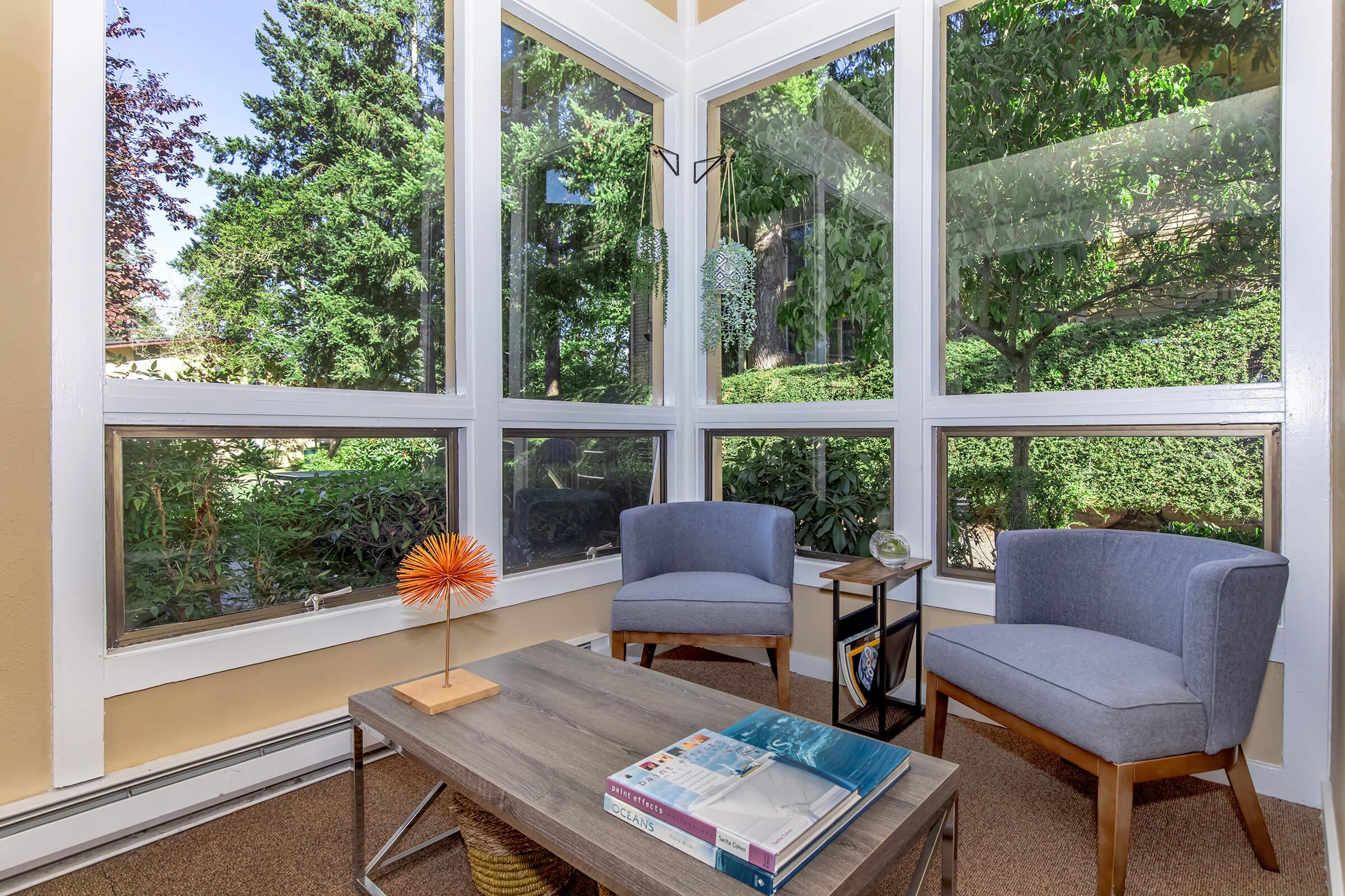 a living room filled with furniture and a large window