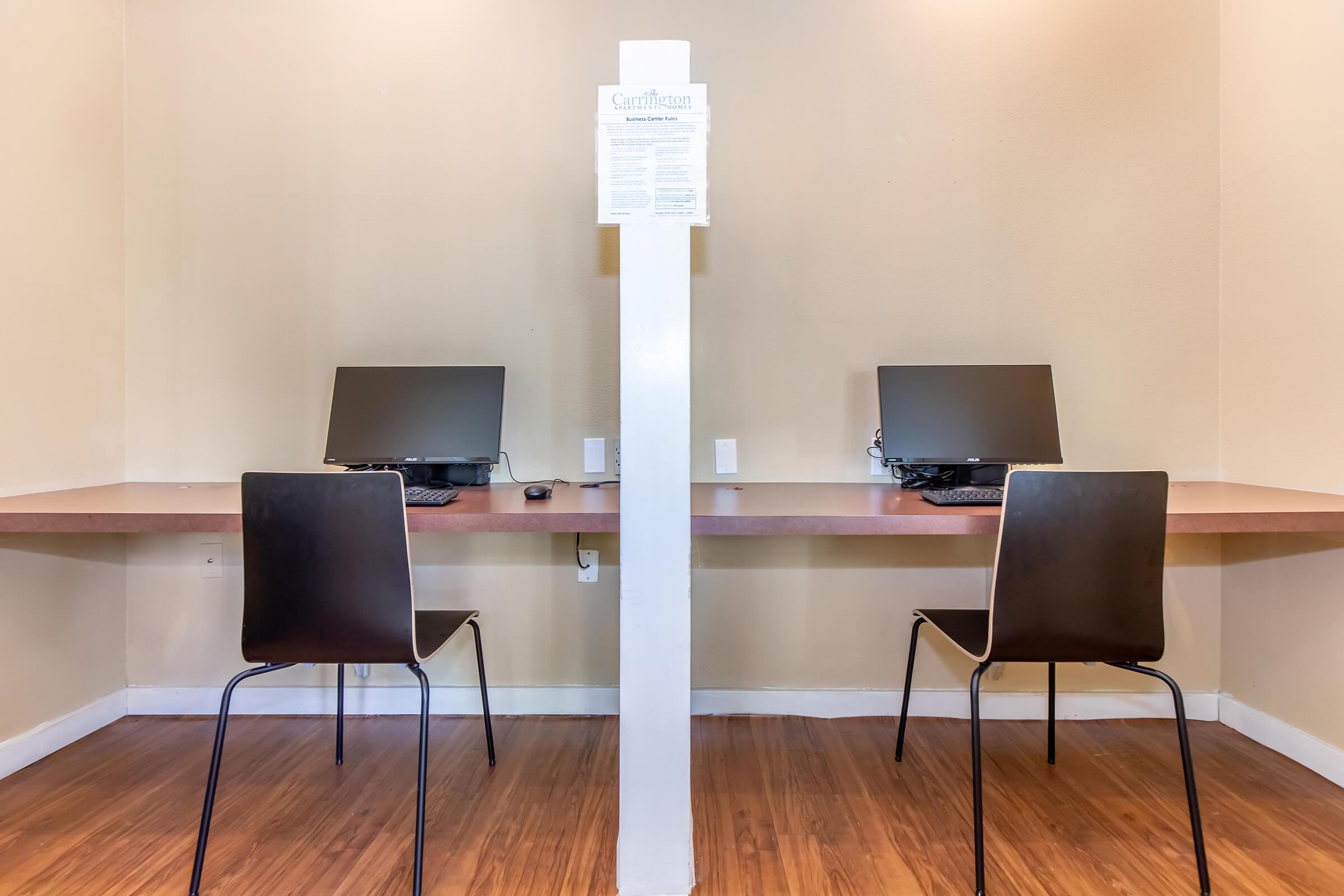 a desk with a laptop in a room