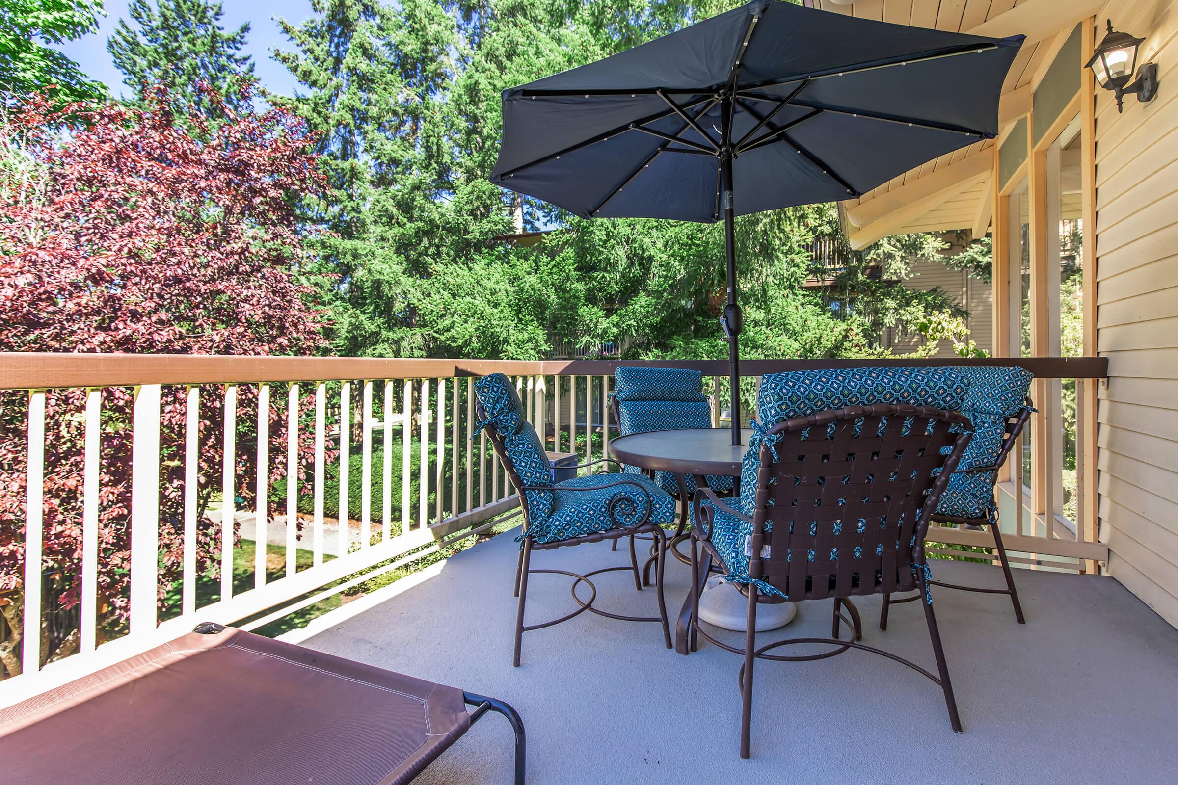 an umbrella sitting on top of a wooden fence