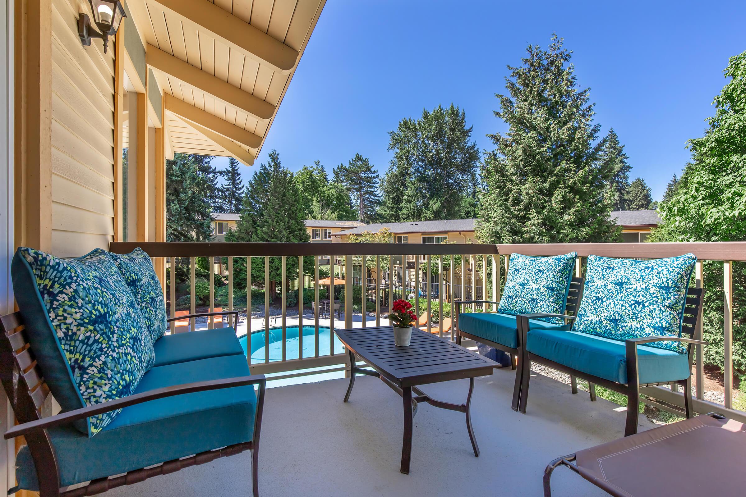 a table topped with a blue umbrella sitting on a bench