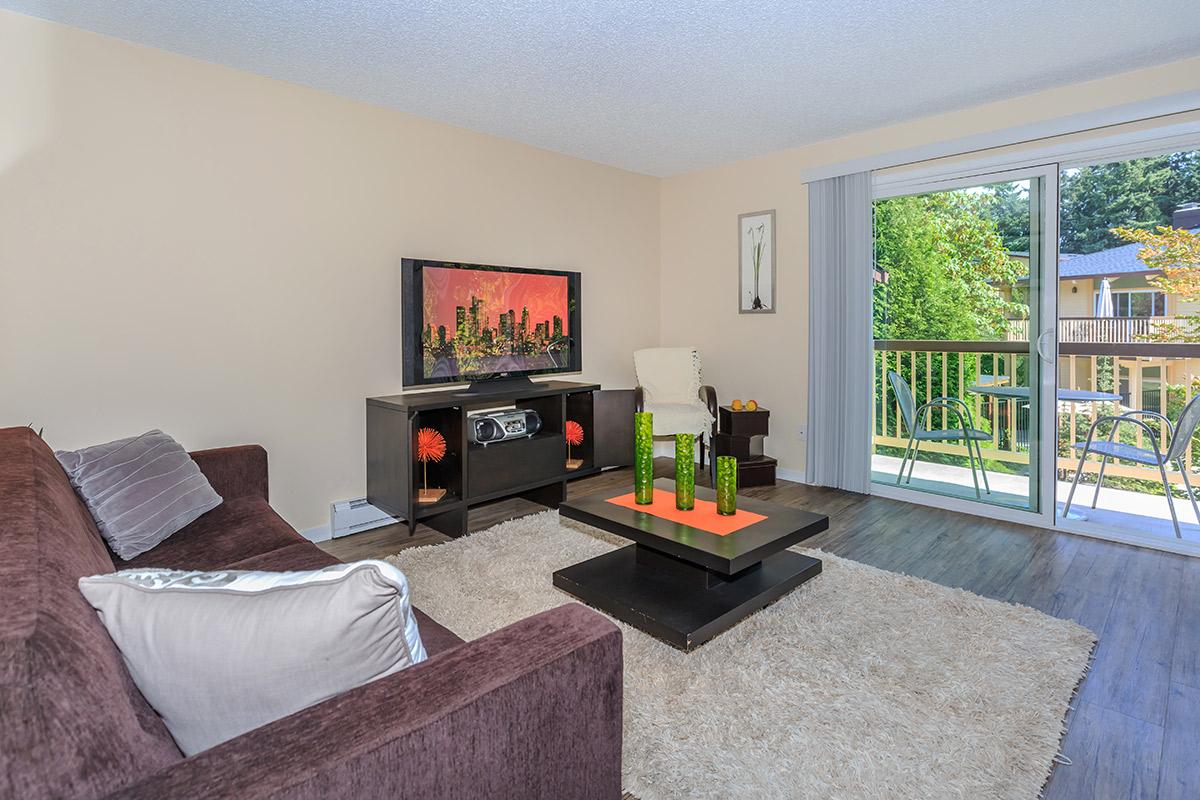 a living room filled with furniture and a flat screen tv