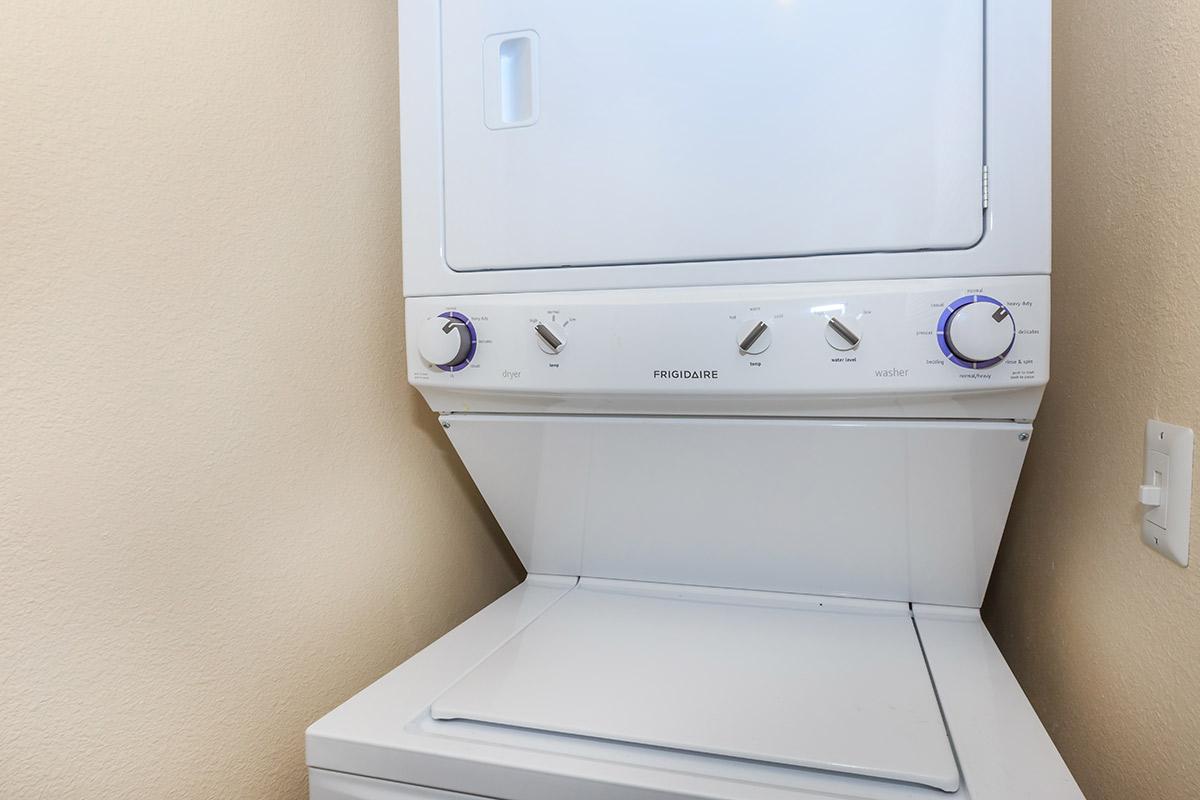 a white microwave oven sitting on top of a refrigerator