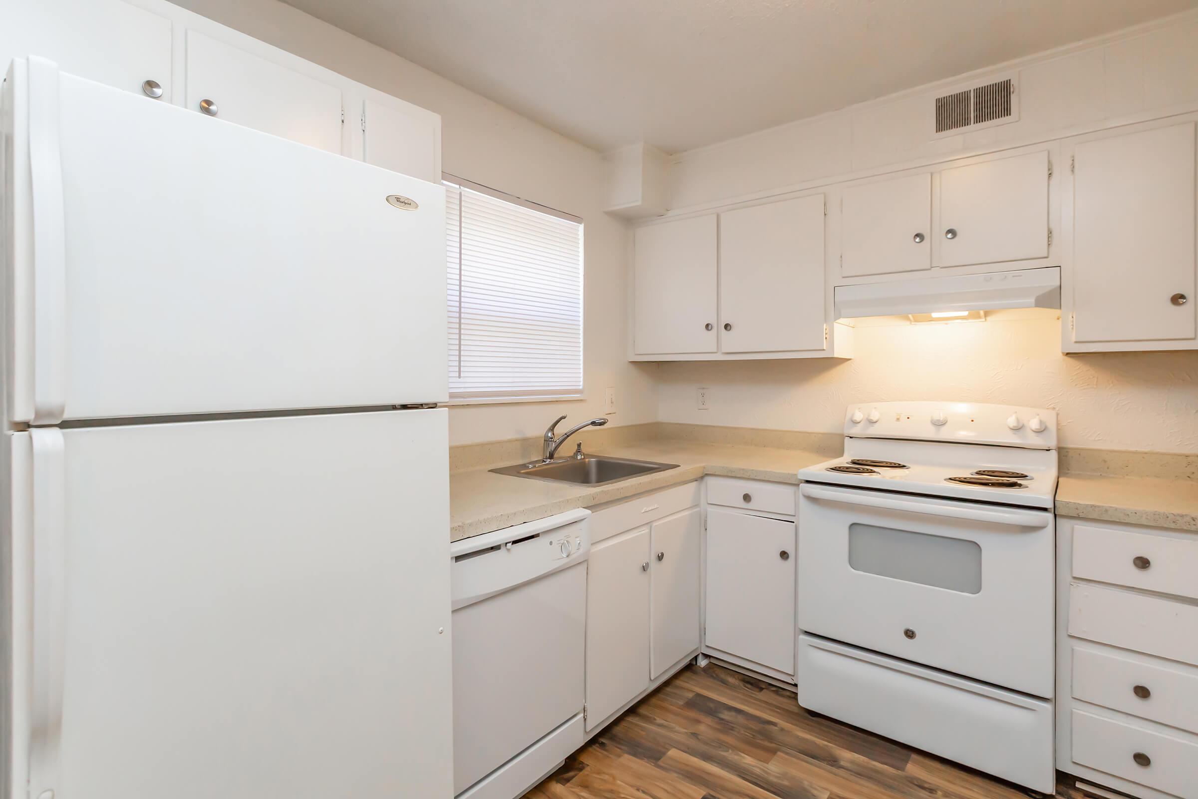 a white refrigerator freezer sitting inside of a kitchen