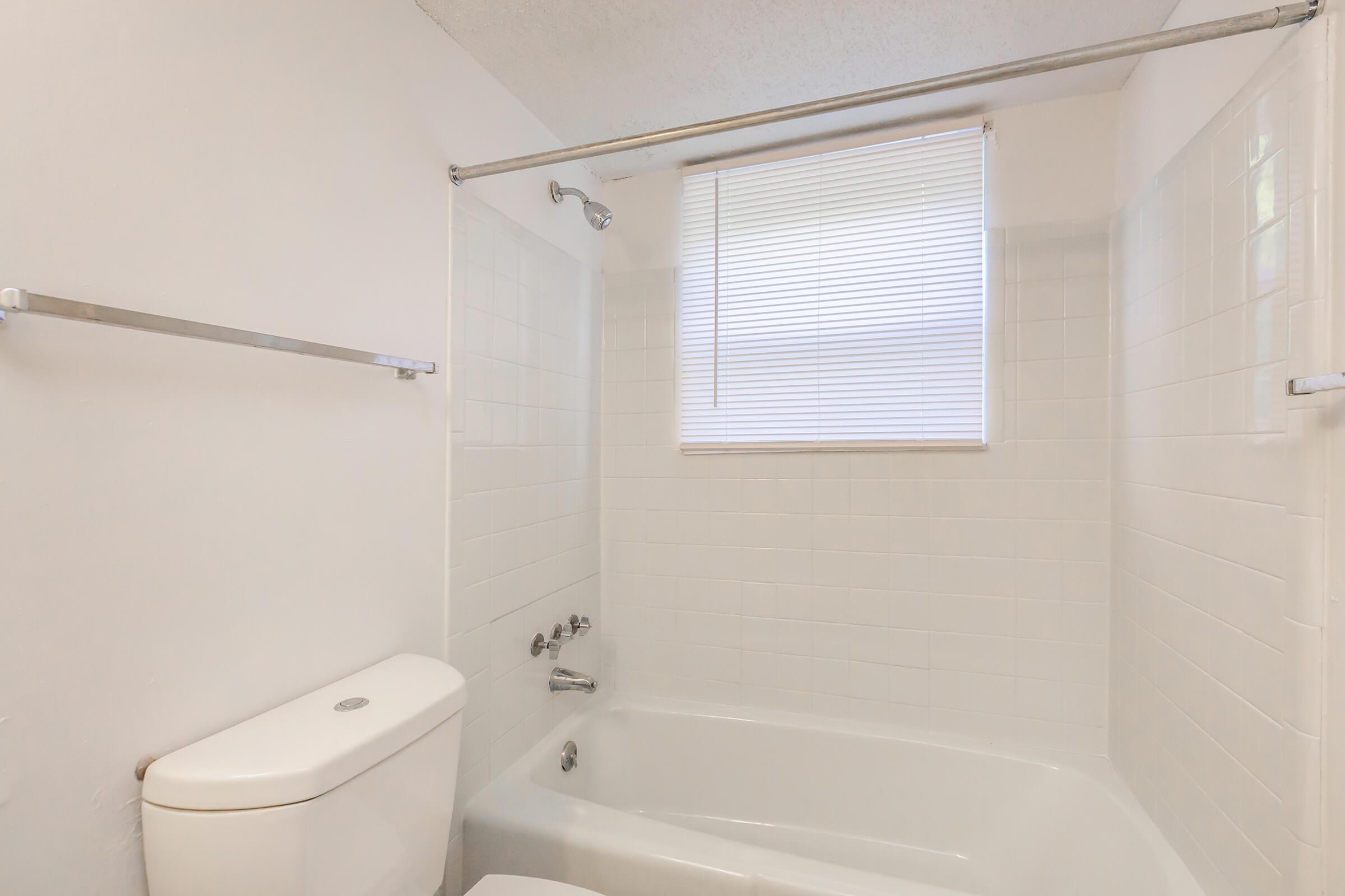 a white tub sitting next to a sink