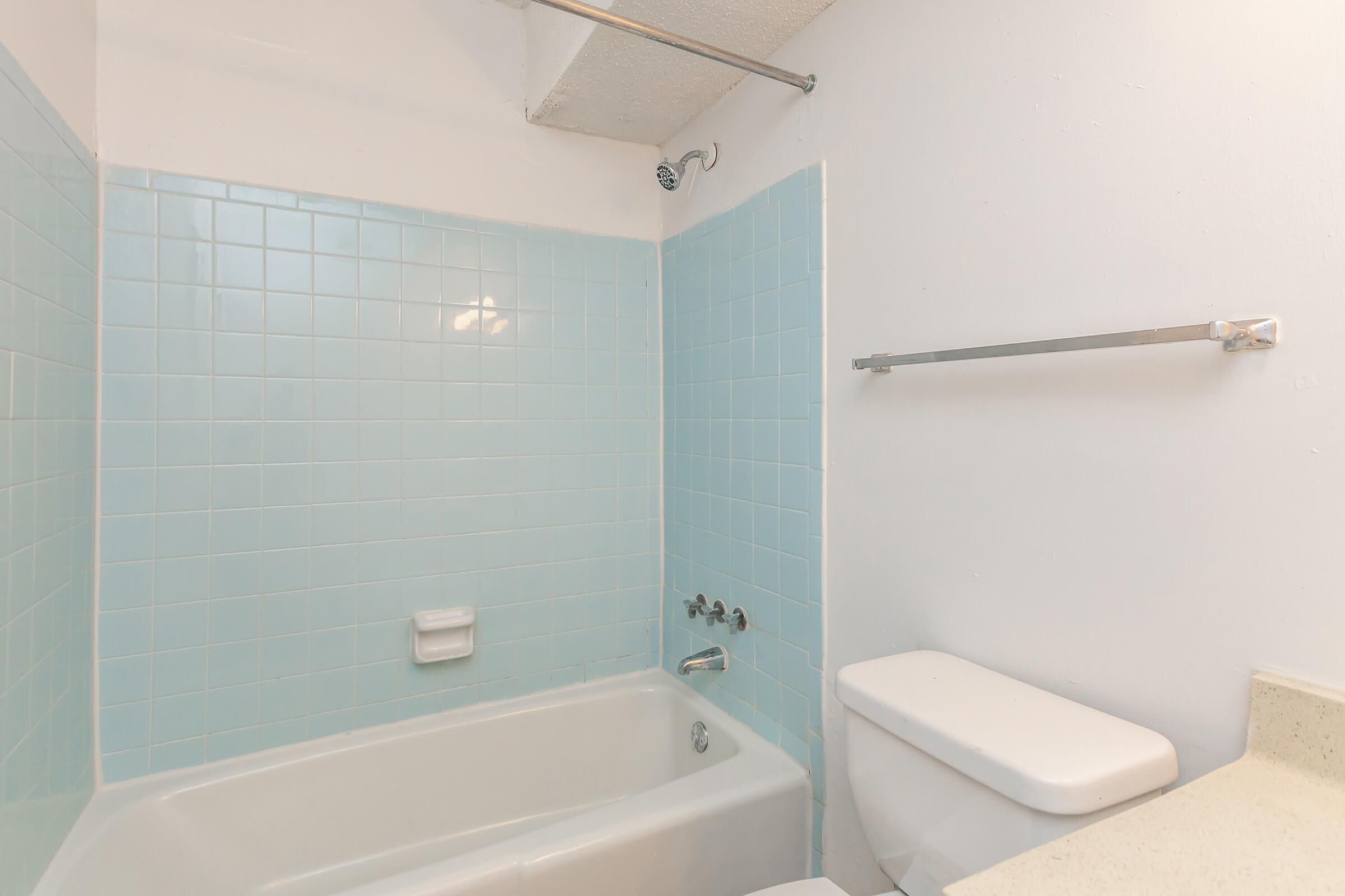 a white tub sitting next to a sink