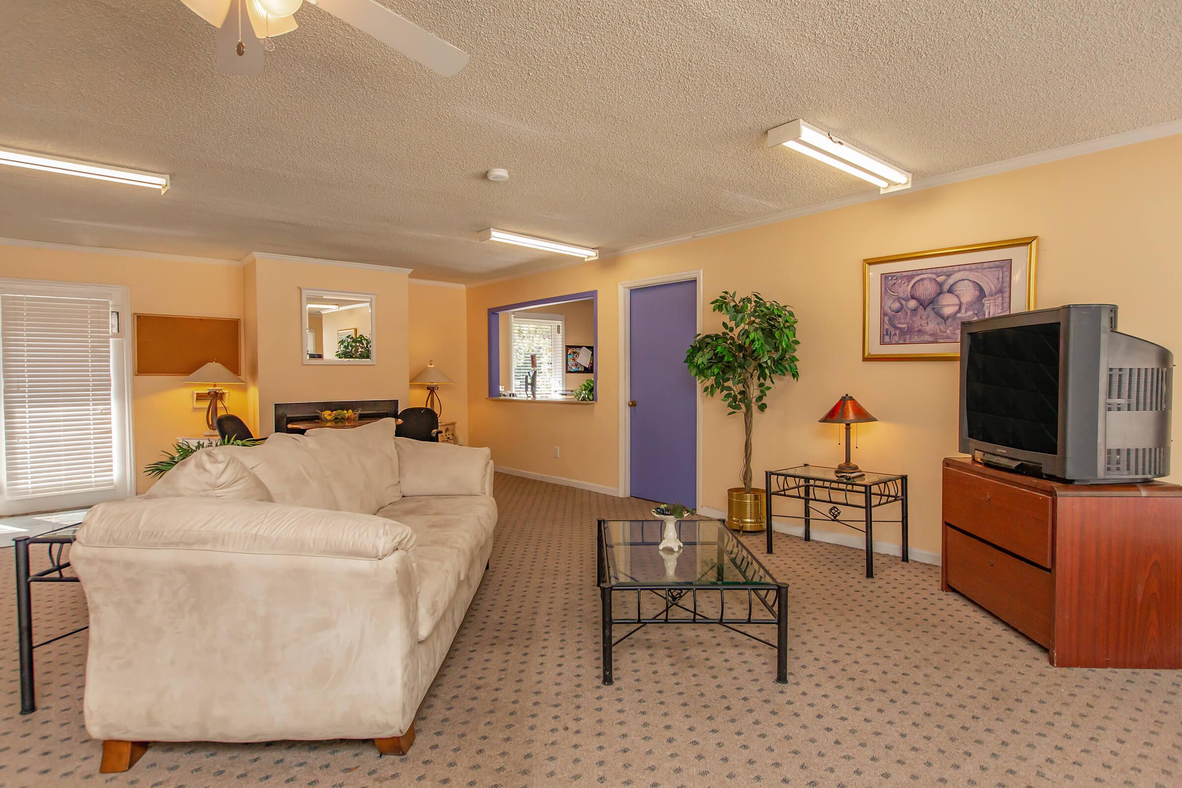 a living room filled with furniture and a flat screen tv