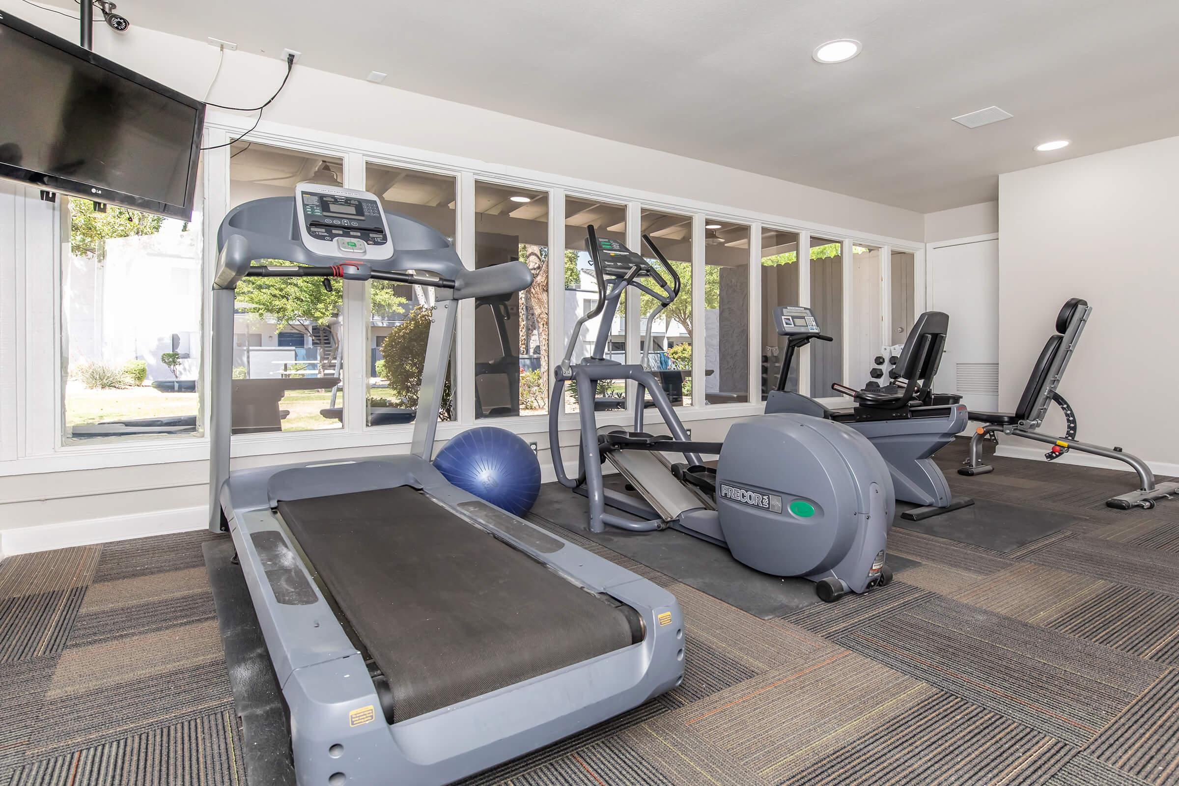 The fitness center at Rise on McClintock with workout equipment.