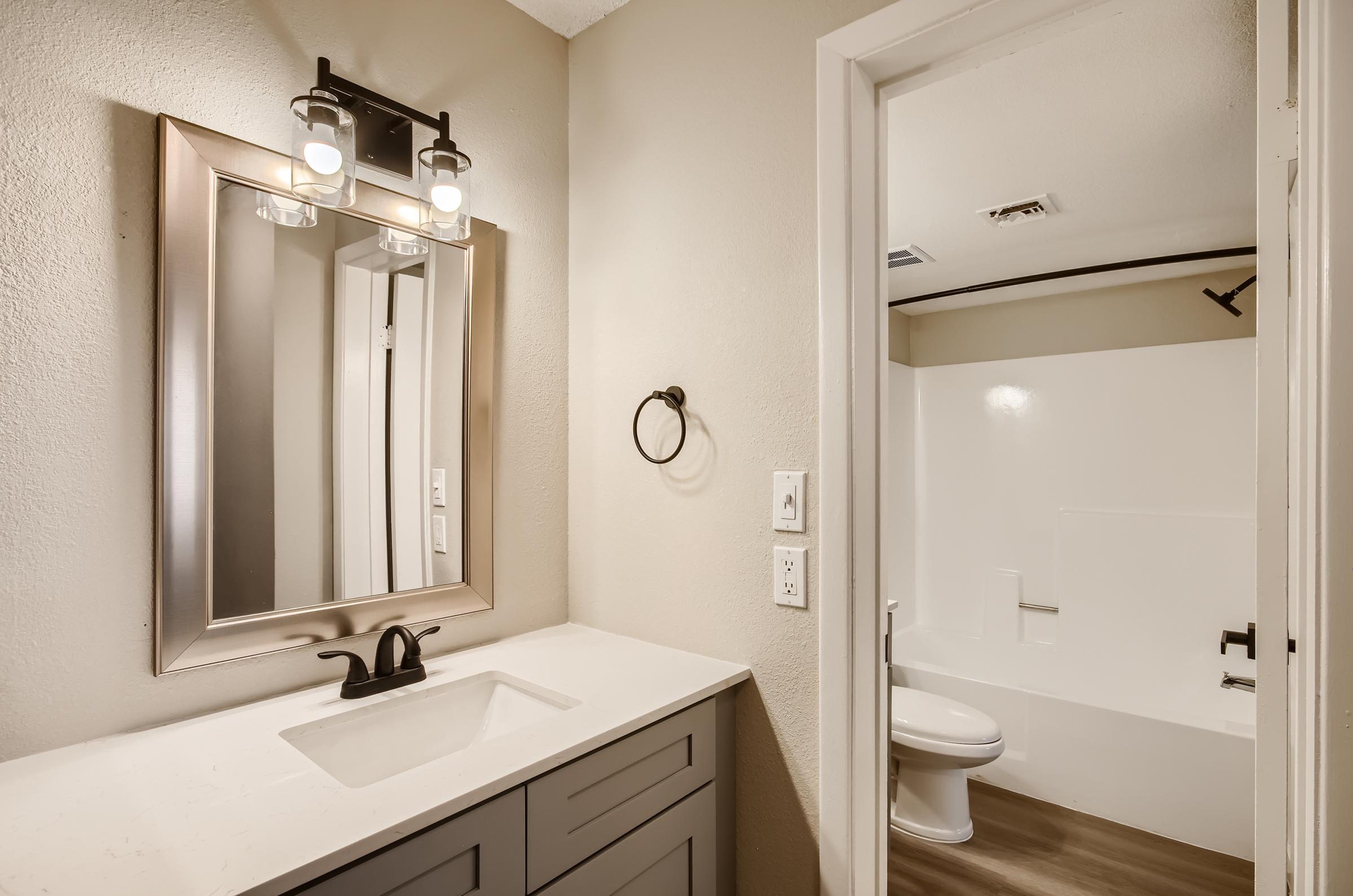An apartment bathroom with a separate toilet area at Rise on McClintock.