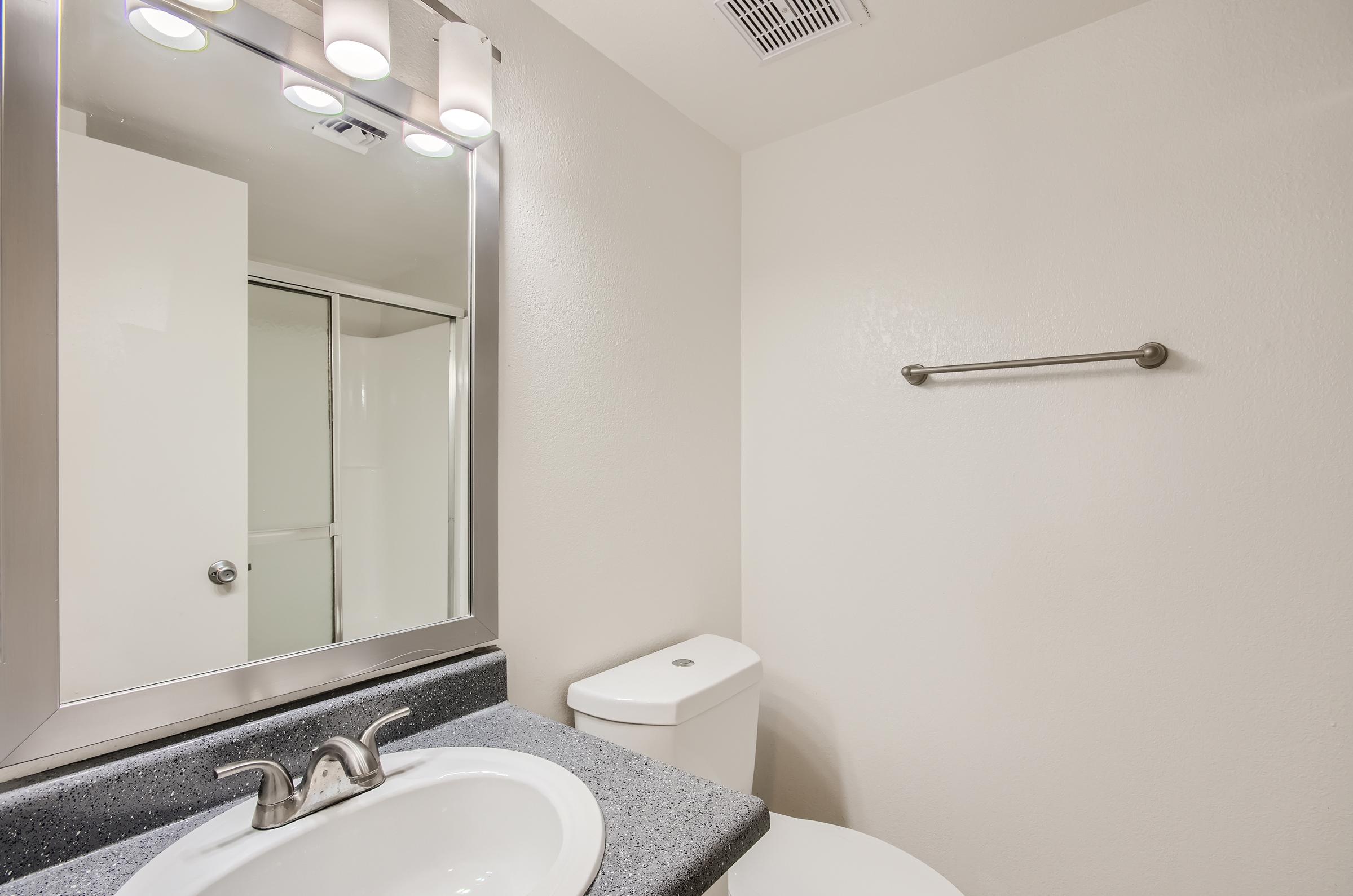 An apartment bathroom with a glass door shower at Rise on McClintock in Tempe, AZ.