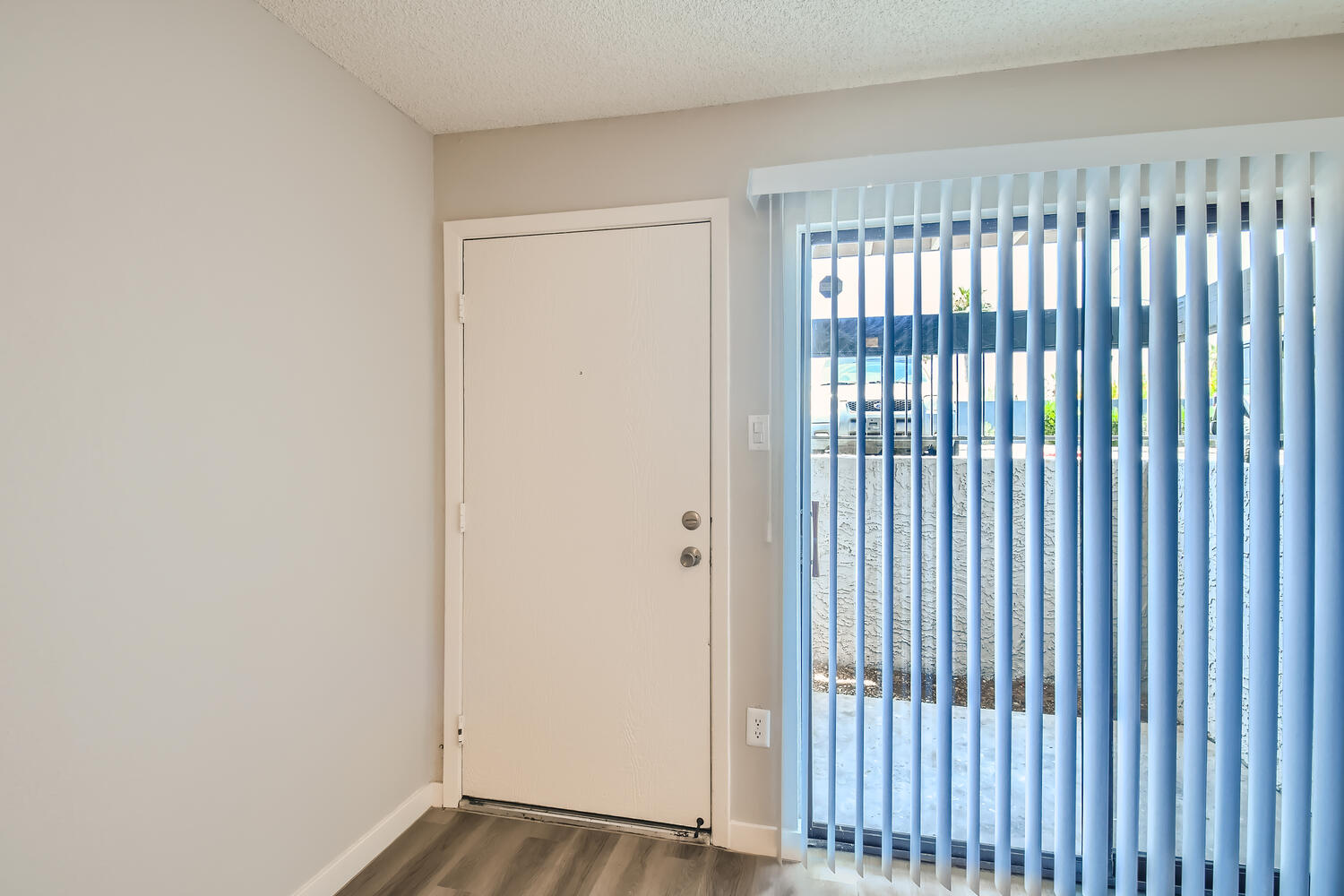 The entrance to a first floor apartment at Rise on McClintock with sliding doors to the patio.