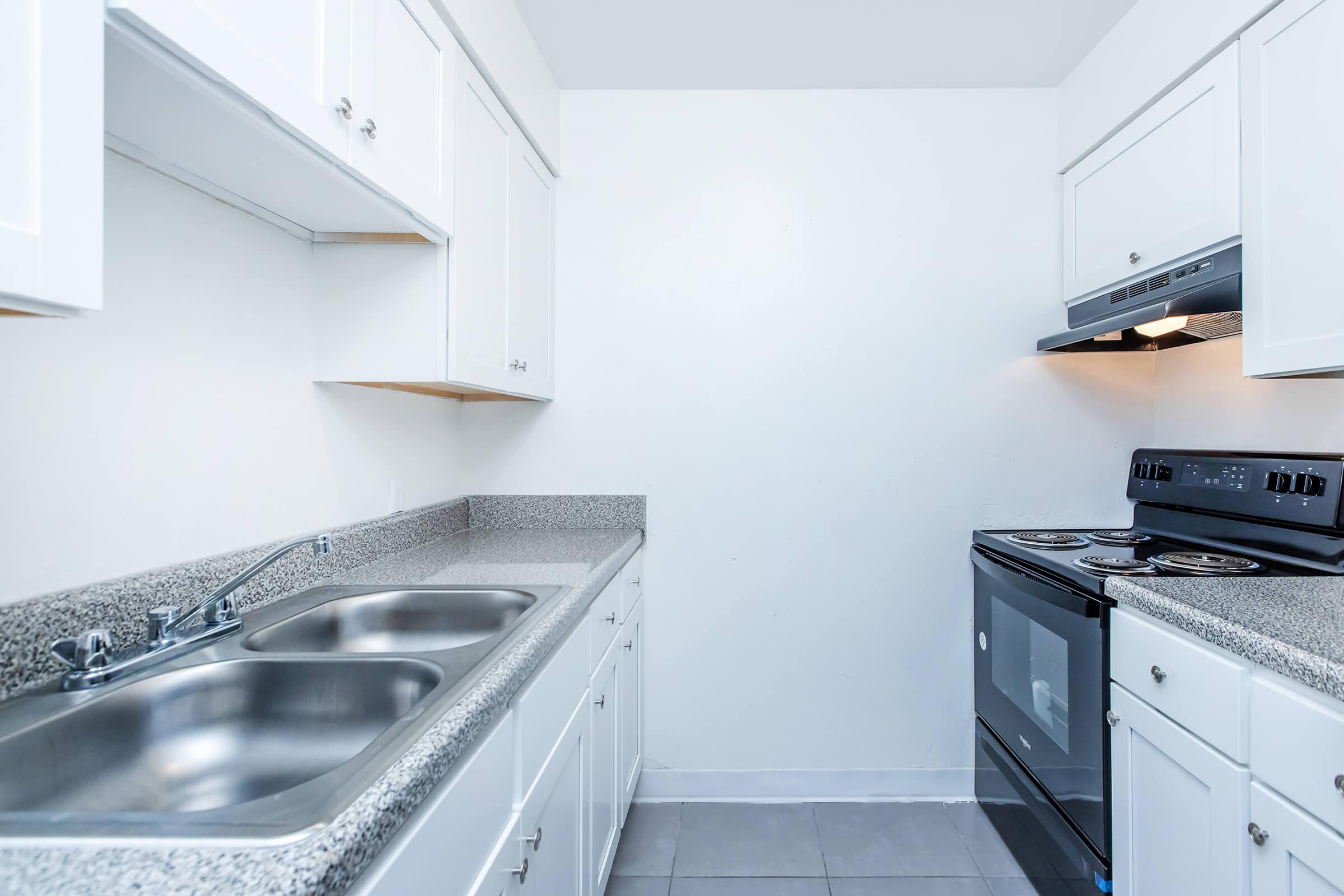 a kitchen with a stove and a sink