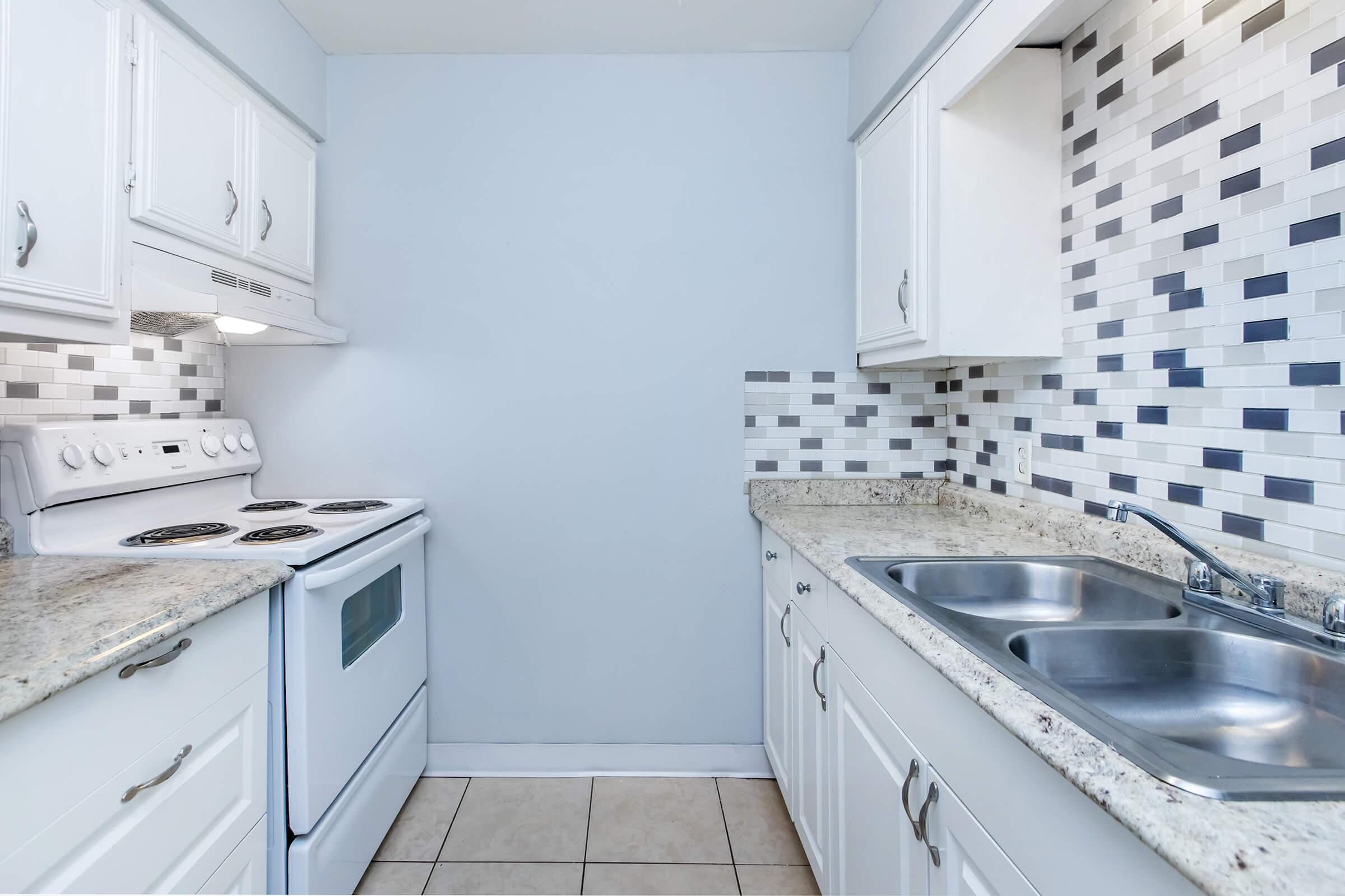 a kitchen with a stove and a sink