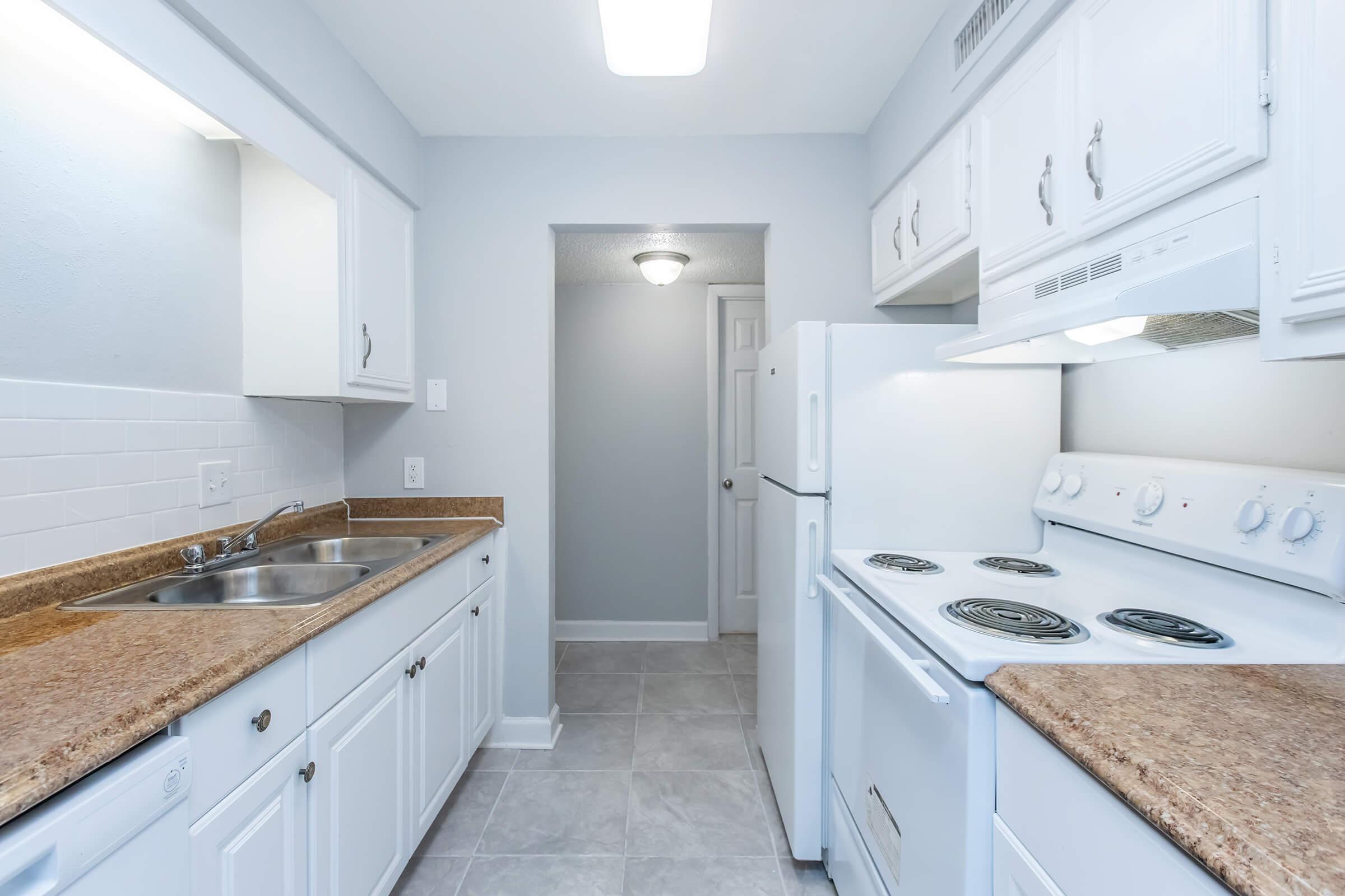 a kitchen with a sink and a refrigerator