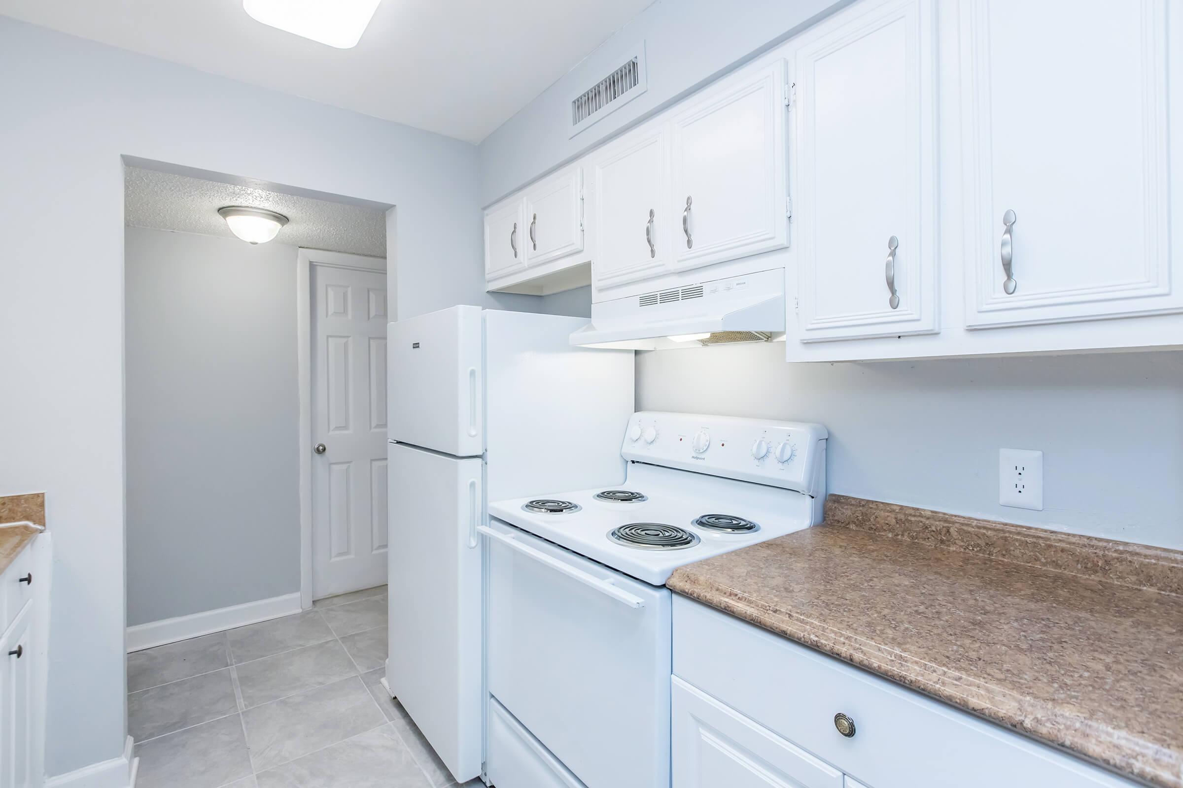 a kitchen with a stove sink and refrigerator