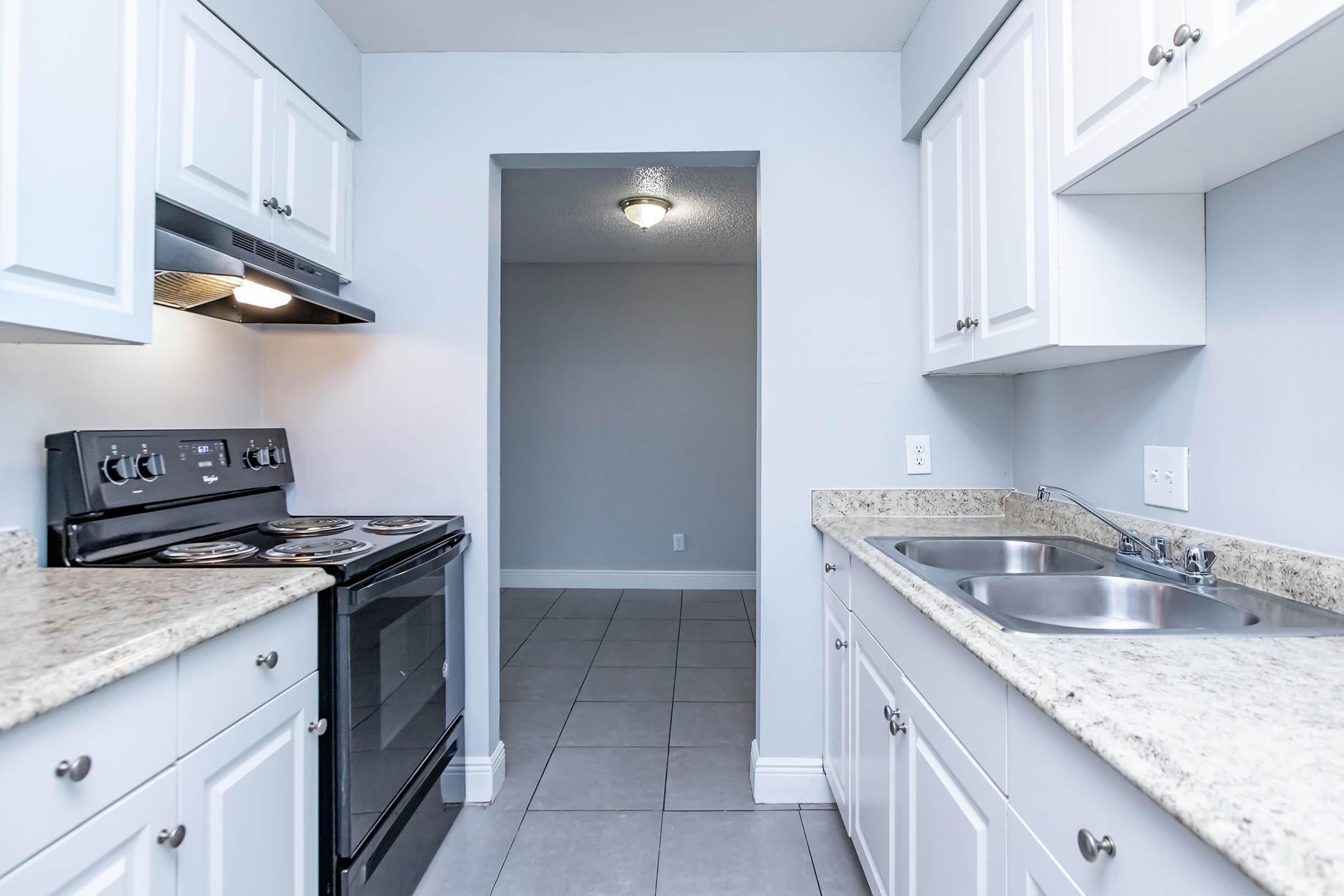 a kitchen with a stove top oven