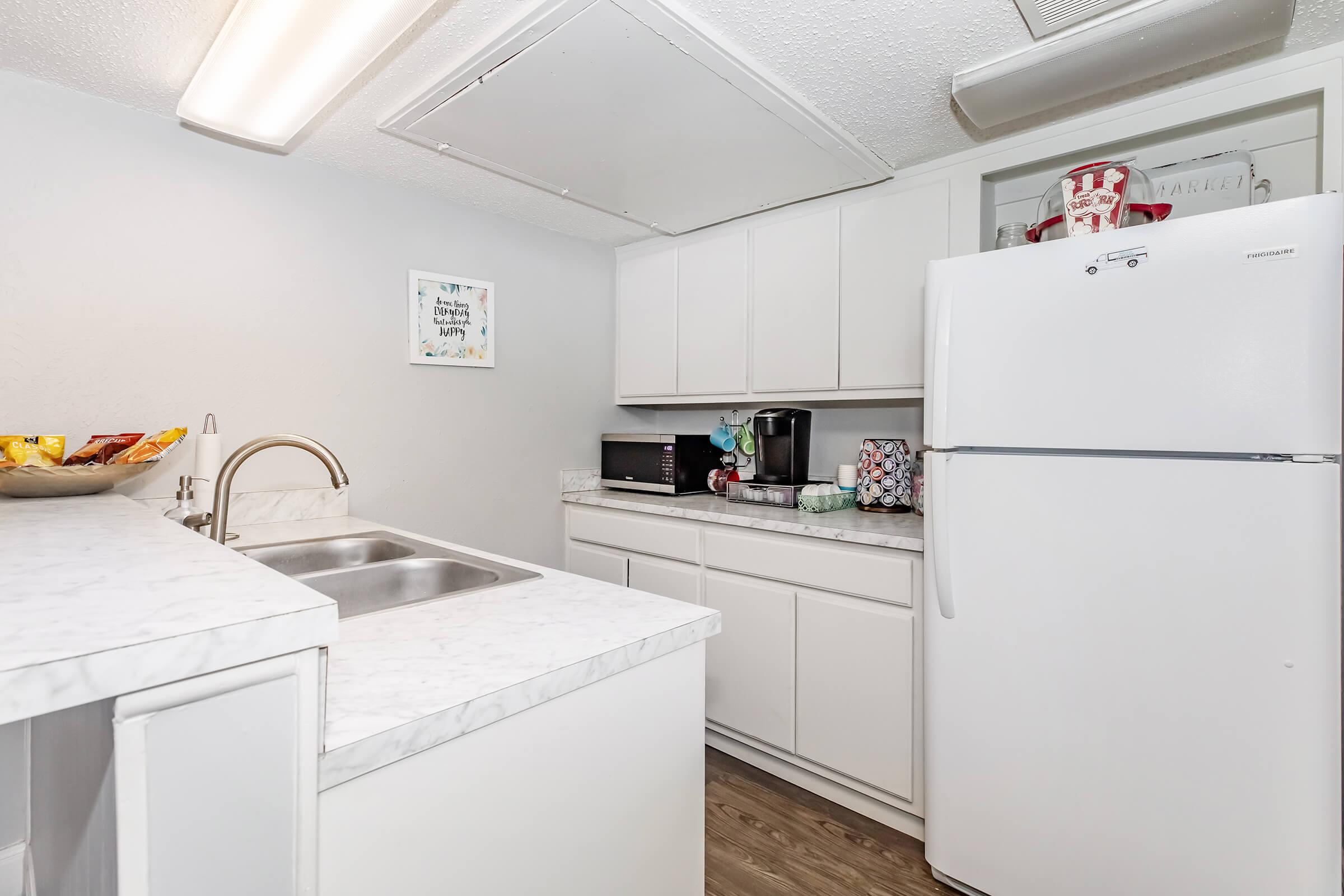 a kitchen with a sink and a refrigerator