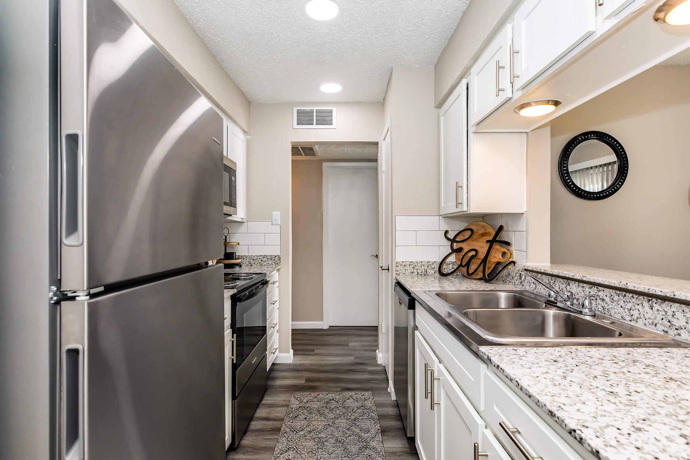 a large kitchen with stainless steel appliances