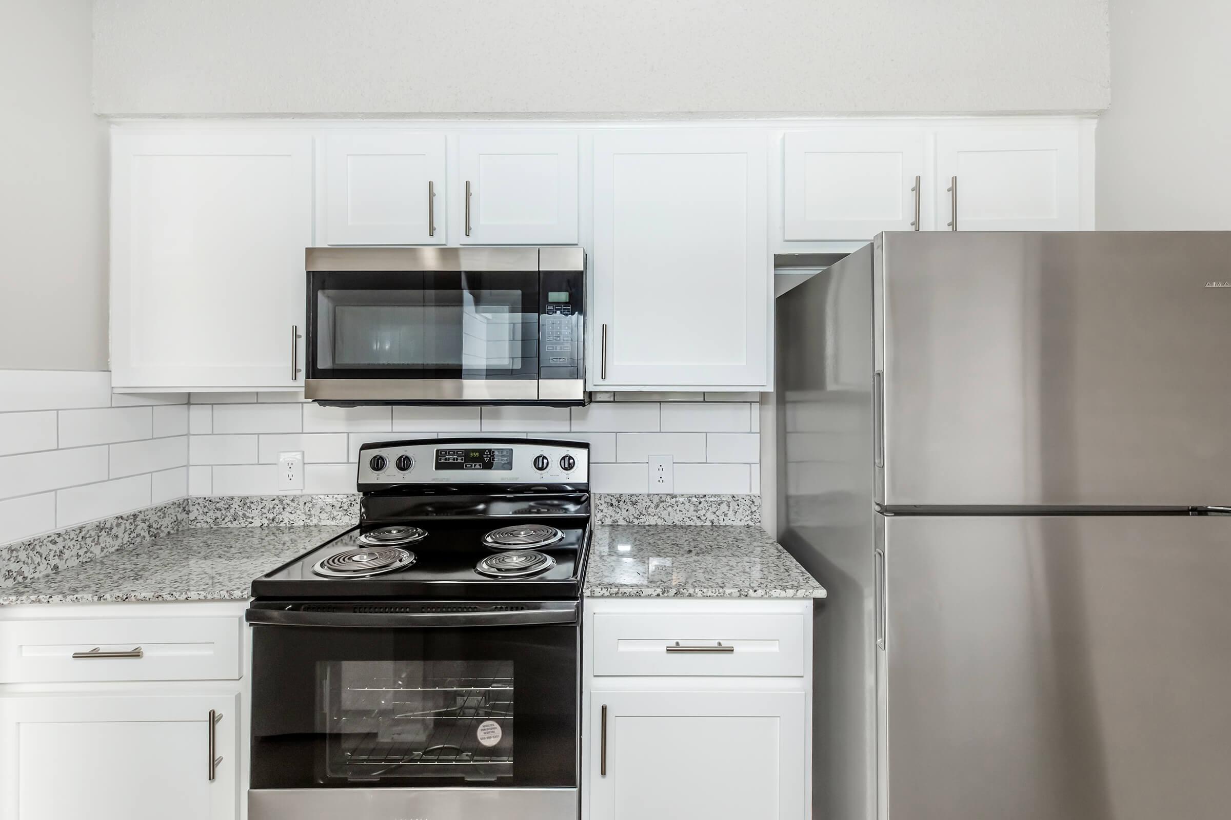 a kitchen with a stove top oven sitting inside of a refrigerator