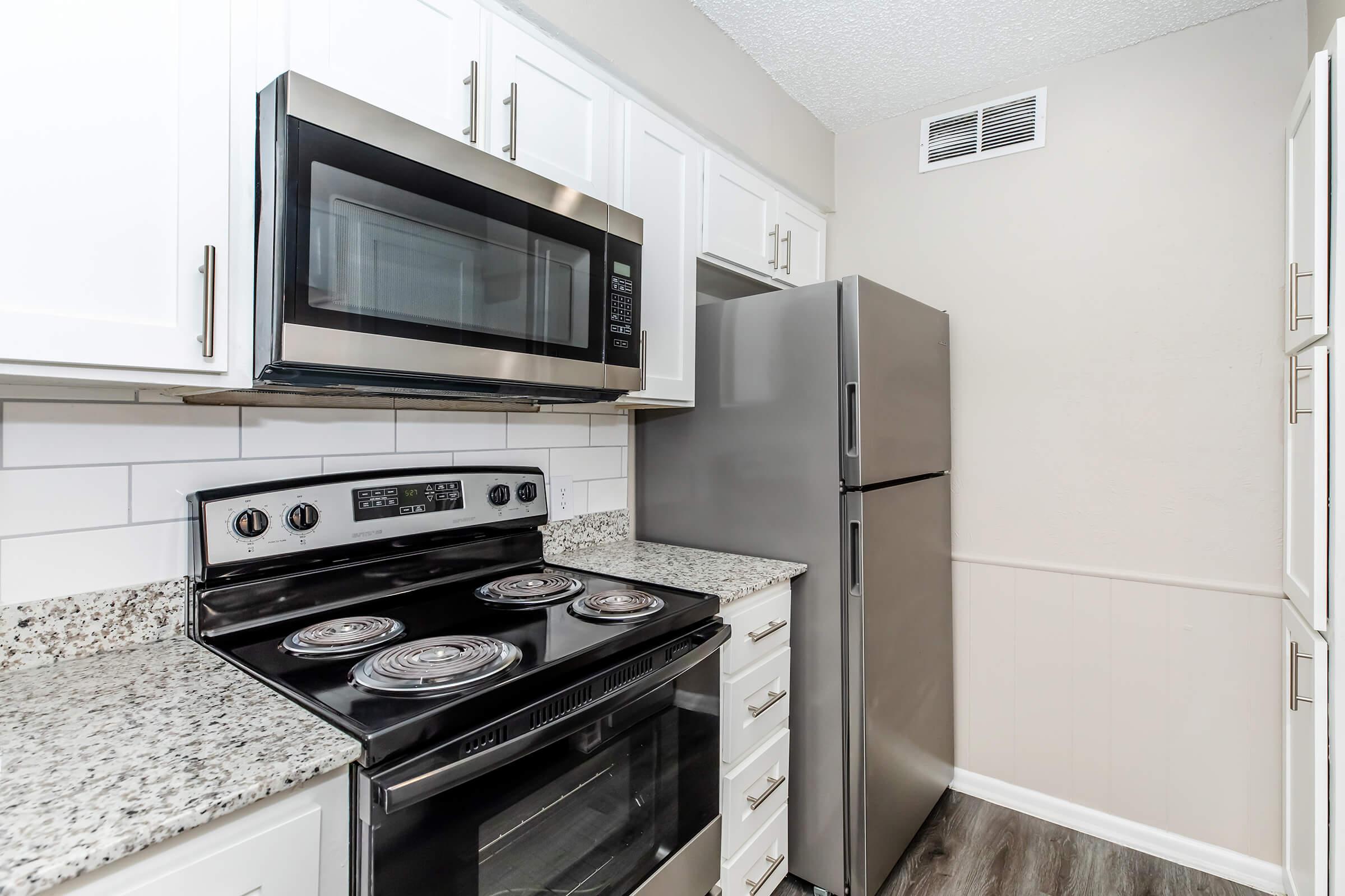 a stove top oven sitting inside of a kitchen