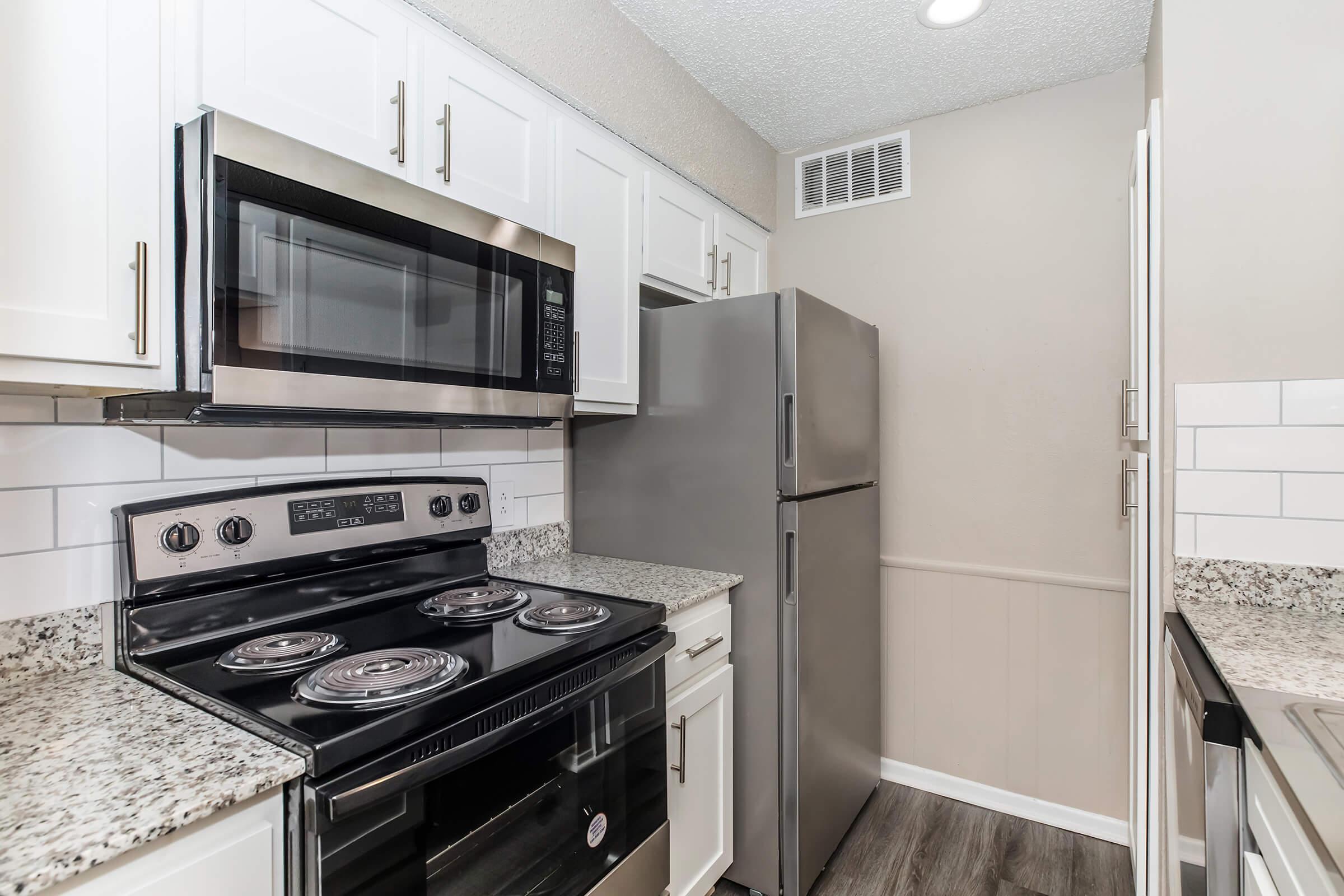 a stove top oven sitting inside of a kitchen