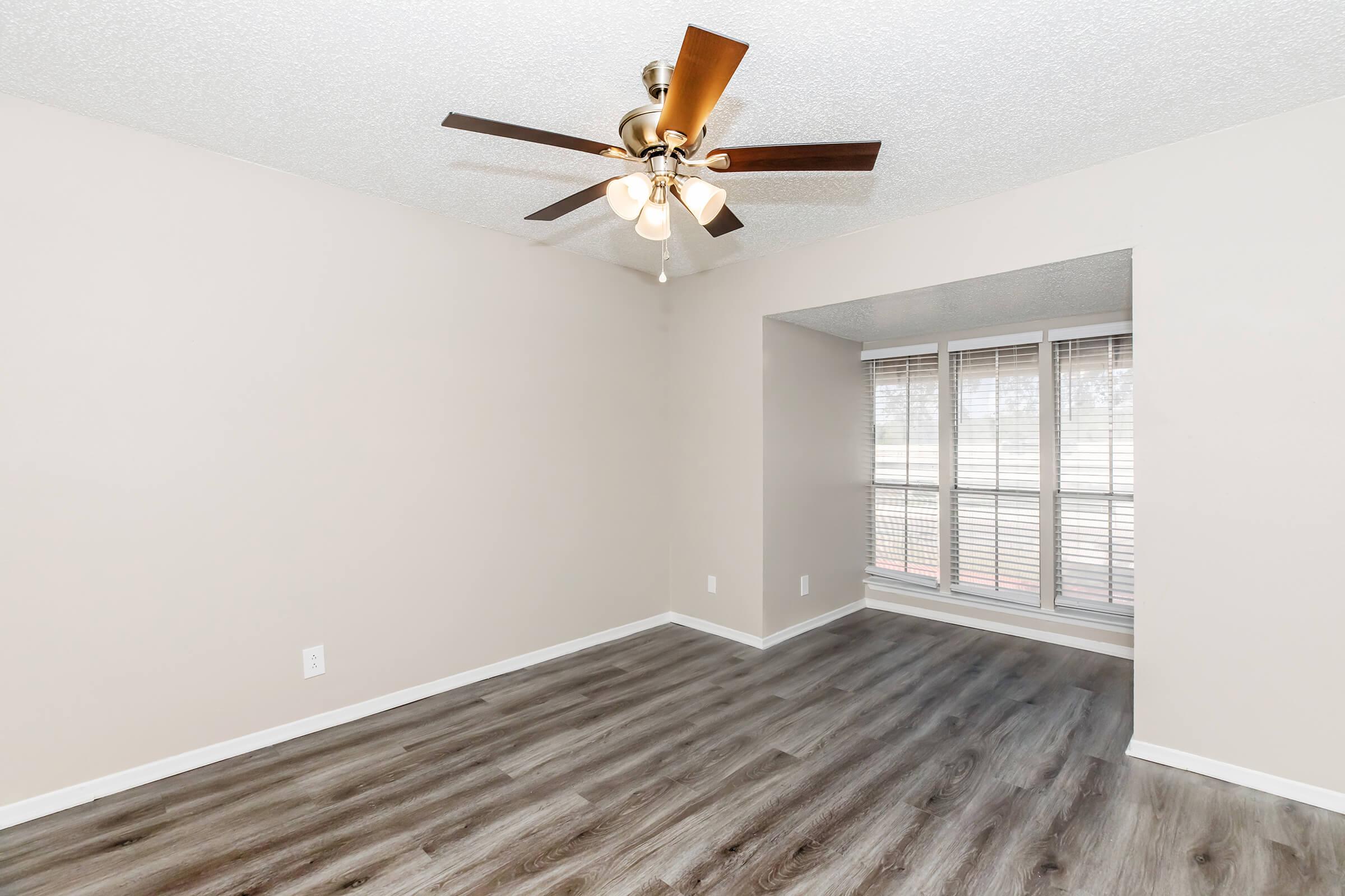 a bedroom with a wooden floor