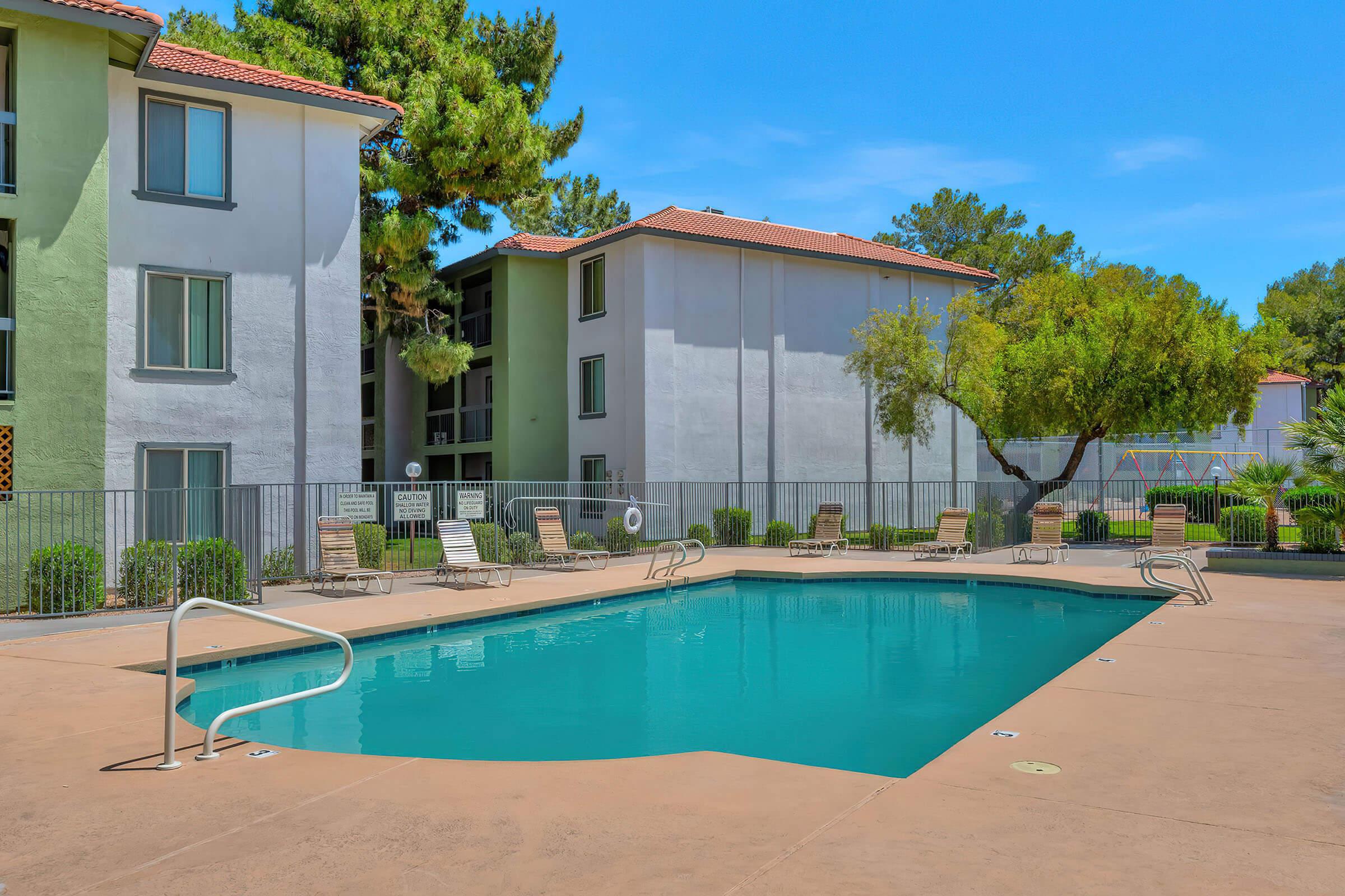 a house with a pool in front of a building