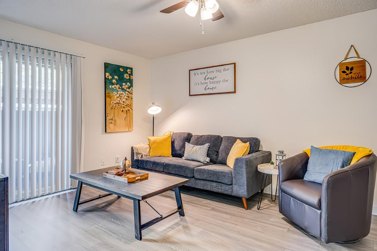 a living room filled with furniture and a tv