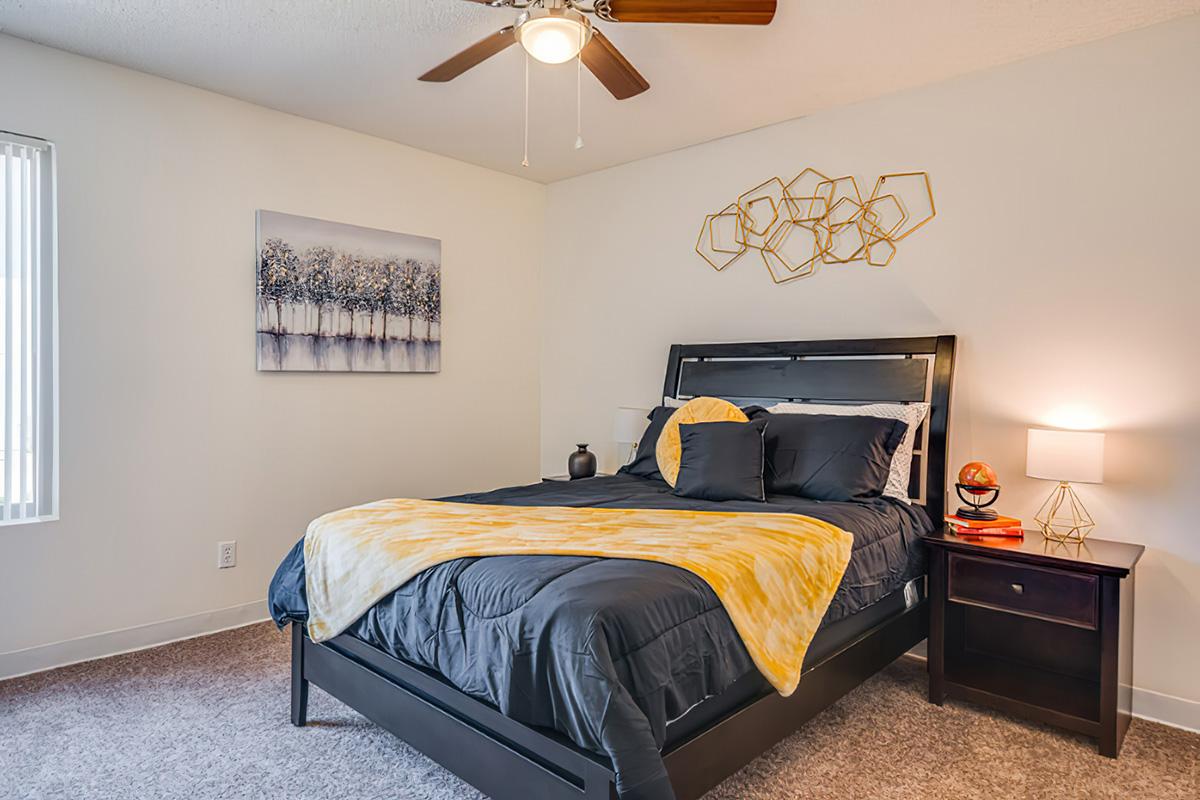 a bedroom with a bed and desk in a room