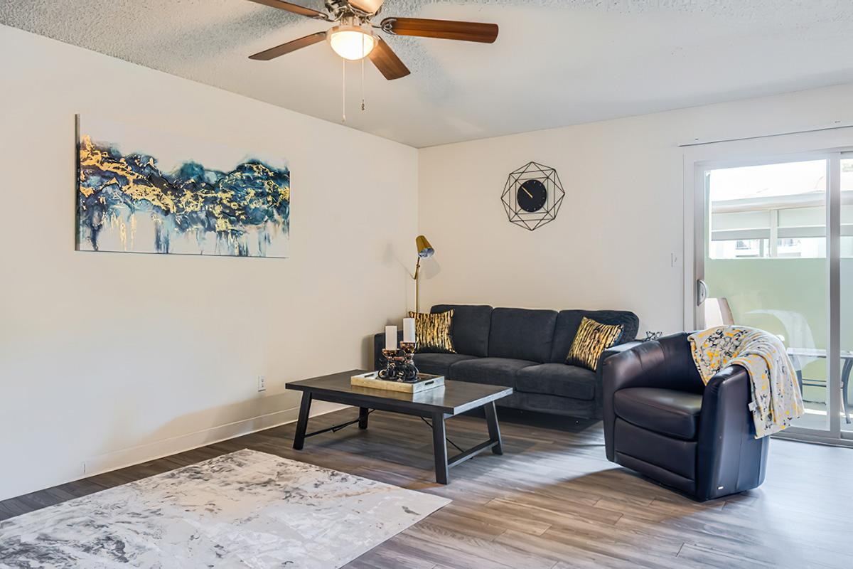 a living room filled with furniture and a large window