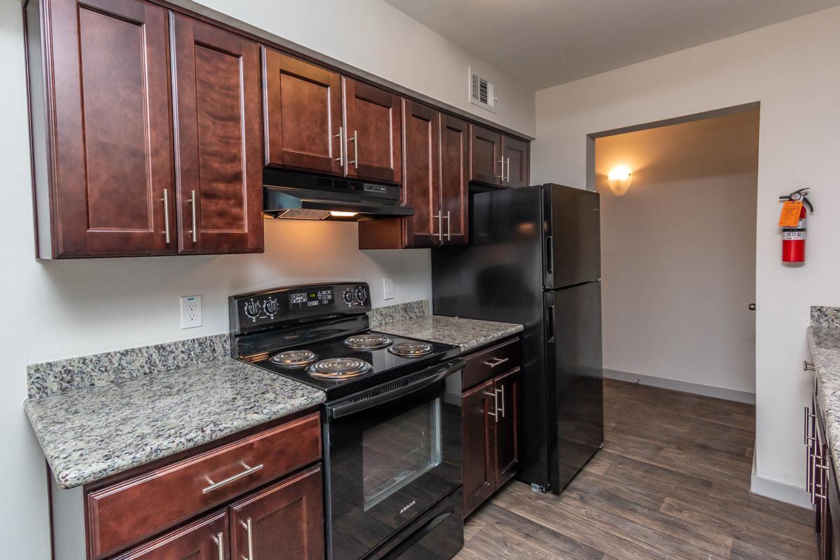 a modern kitchen with stainless steel appliances and wooden cabinets