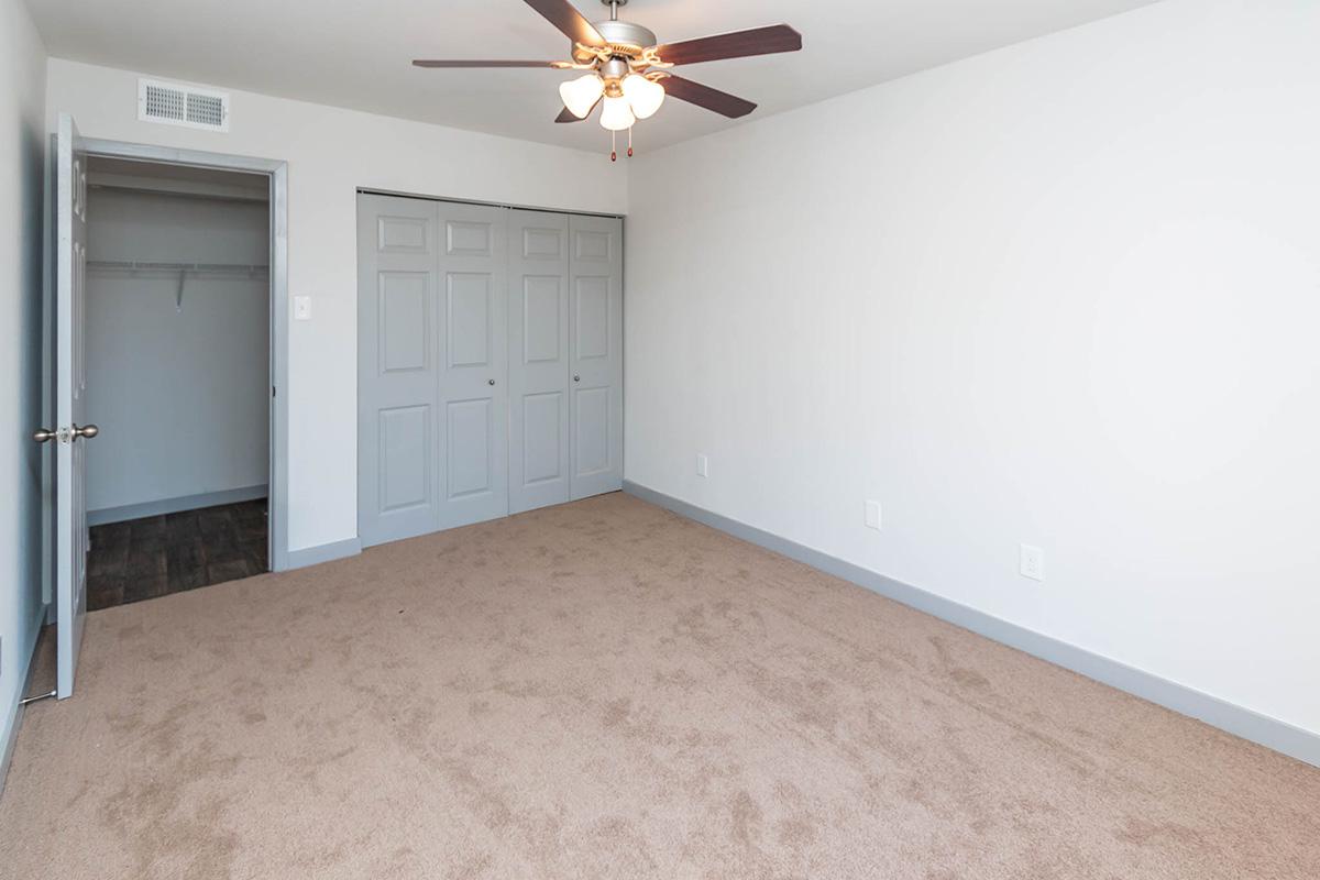 a bedroom with a bed in a small room