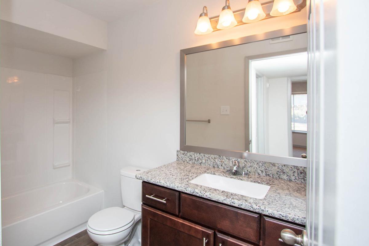 a kitchen with a sink and a mirror