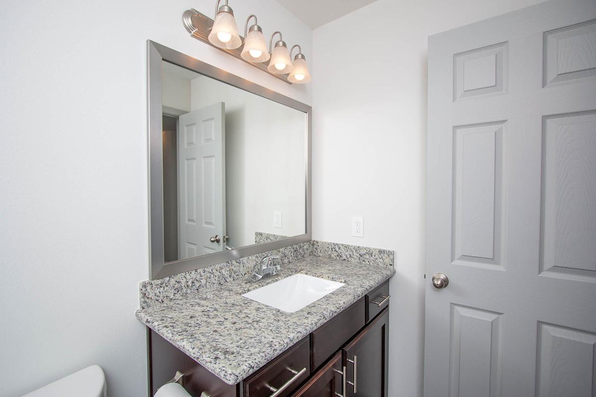 a room with a sink and a mirror