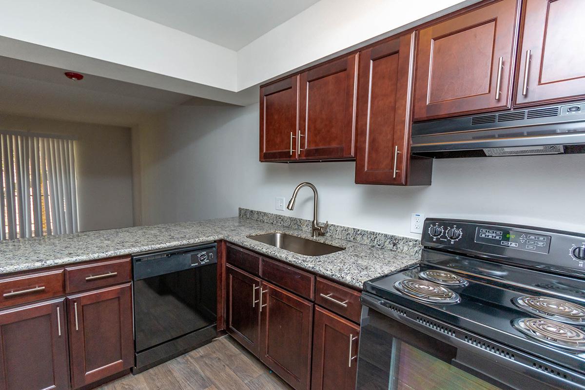 a kitchen with stainless steel appliances and wooden cabinets