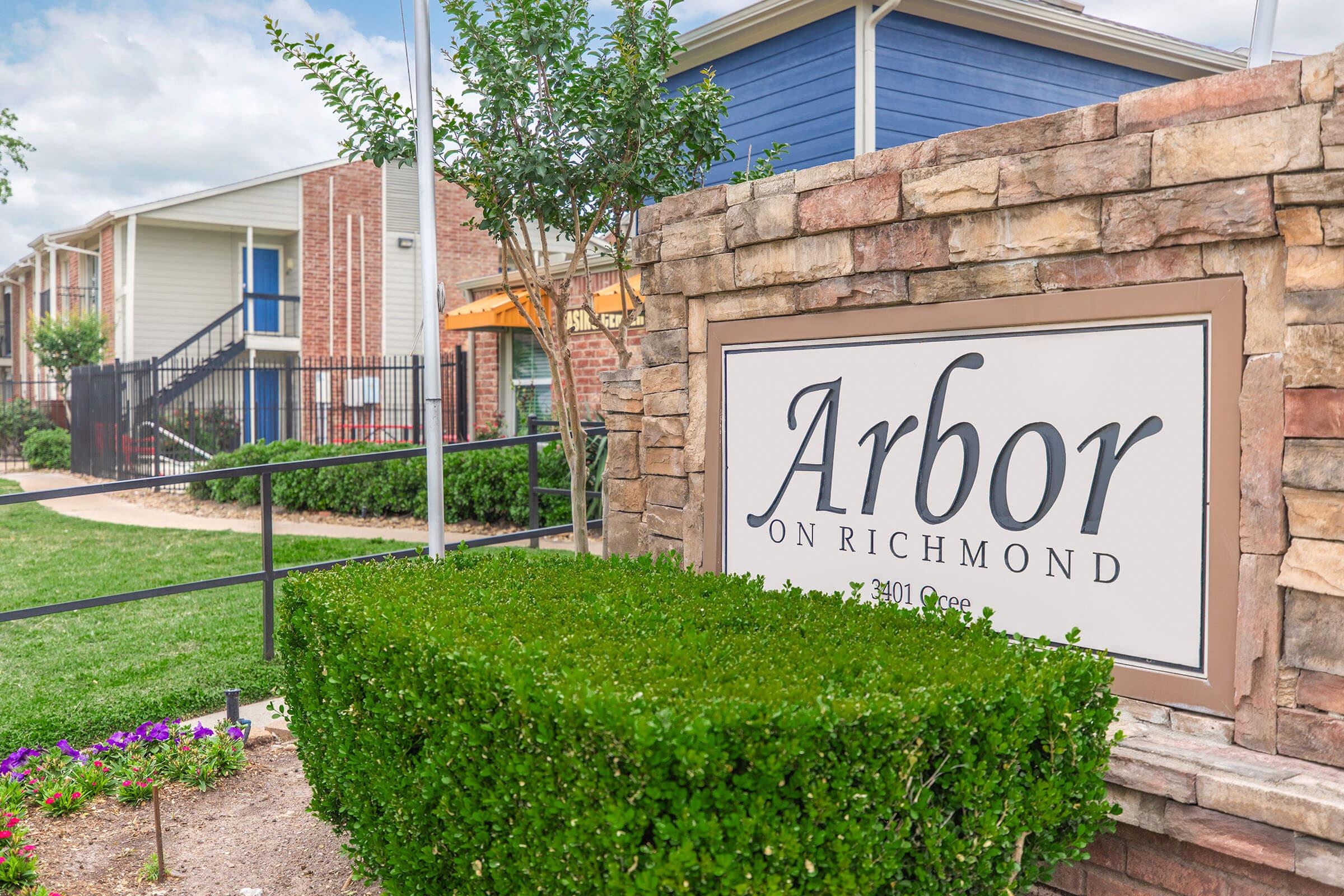 a sign in front of a brick building