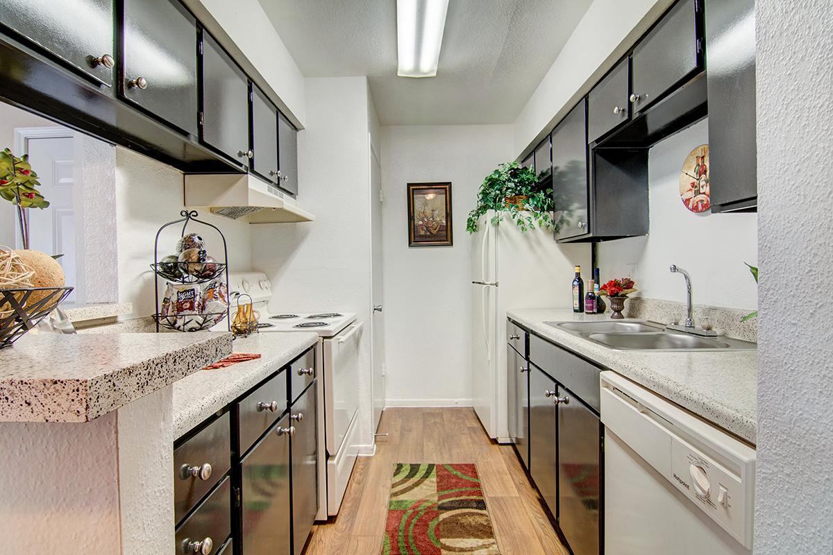 a kitchen with a sink and a refrigerator