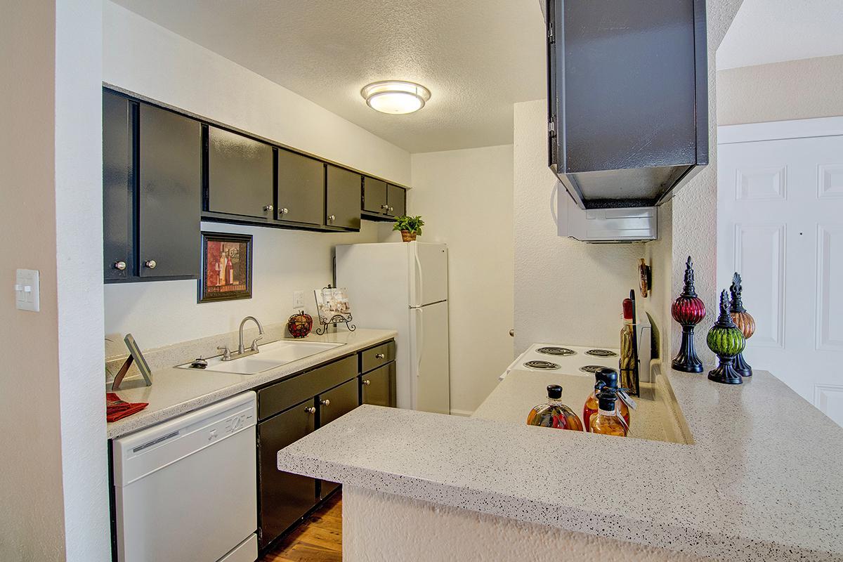 a bedroom area with a sink and a mirror